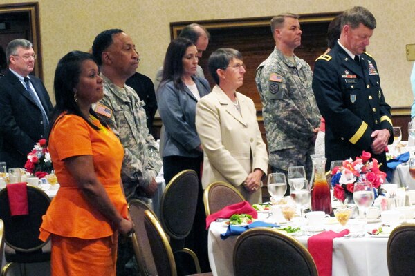 Retired Brig. Gen. Rebecca Halstead, center, joins Team Redstone military leaders and their spouses in standing for the invocation during the National Prayer Luncheon on June 9 in The Summit on Redstone Arsenal. 