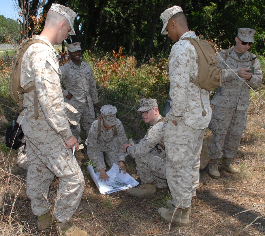 Marines study a map using a protractor to plot the correct path they will follow to their next checkpoint during land navigation training May 16 at the Corporals Course aboard Marine Corps Logistics Base Albany.