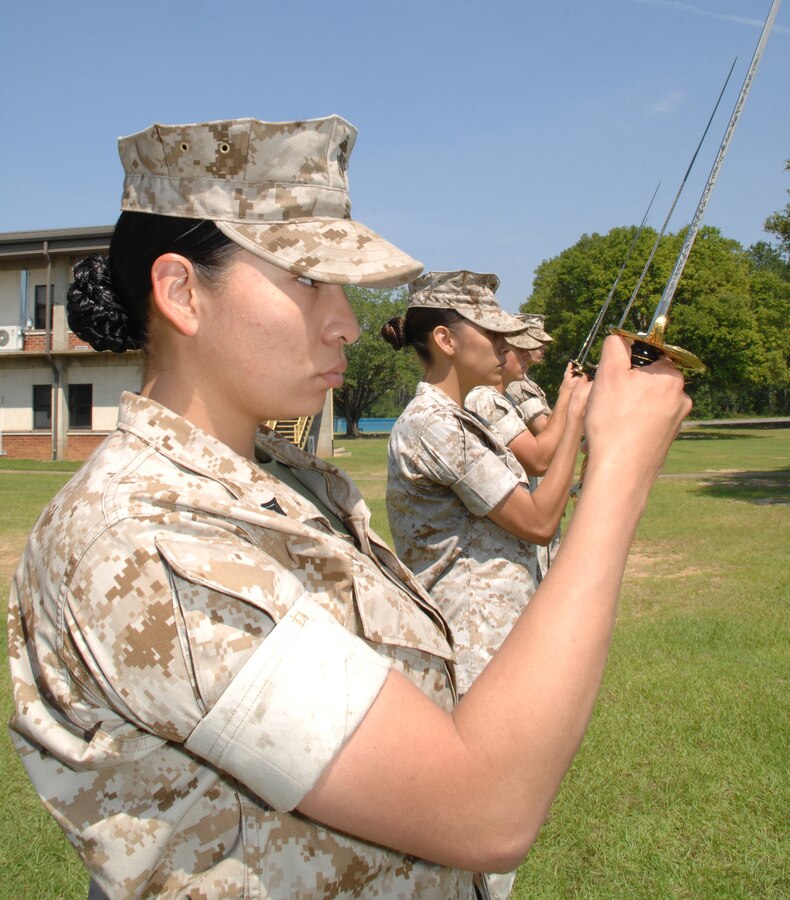 Cpl. Adrianna Rouillard, armorer, Headquarters and Service Company, Combat Logistics Battalion-453, Combat Logistics Regiment-4, Aurora, Colorado, practices saluting with a sword May 22 during the Corporals Course held at Marine Corps Logistics Base Albany.