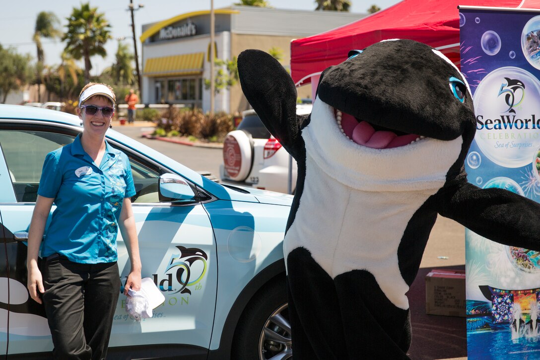 MARINE CORPS AIR STATION MIRAMAR, Calif. – Gabi Jarrett, an entertainment representative with SeaWorld, stands next to Shamu, the theme park’s mascot, during the Marine Corps Air Station Miramar Information Tickets and Tours Expo 2014 aboard Marine Corps Air Station Miramar, Calif., June 12. SeaWorld was one of 26 vendors at the ITT Expo displaying what they have to offer service members stationed at MCAS Miramar. This is the first expo the air station has hosted in five years. 