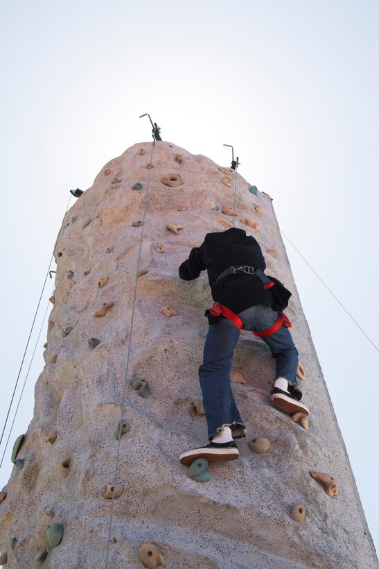 Cpl. Ruben Gomez, administrative specialist with installation personnel administration center, climbs a rock wall at the Marine Corps Air Station Miramar Information Tickets and Tours Expo 2014, aboard Marine Corps Air Station Miramar, Calif., June 12. Climbing the rock wall was one of the free events and offers provided for service members, department of defense employees and their families at the ITT Expo. This is the first expo the air station has hosted in five years. 