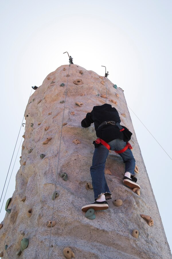Cpl. Ruben Gomez, administrative specialist with installation personnel administration center, climbs a rock wall at the Marine Corps Air Station Miramar Information Tickets and Tours Expo 2014, aboard Marine Corps Air Station Miramar, Calif., June 12. Climbing the rock wall was one of the free events and offers provided for service members, department of defense employees and their families at the ITT Expo. This is the first expo the air station has hosted in five years. 