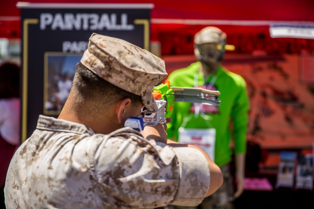 MARINE CORPS AIR STATION MIRAMAR, Calif. – Cpl. Jaime Santos, ground radio repair specialist with Headquarters and Headquarters Squadron, shoots at a mannequin to win a free paintball session during the Marine Corps Air Station Miramar Information Tickets and Tours Expo 2014, aboard Marine Corps Air Station Miramar, Calif., June 12. The game was one of the free events and offers provided for service members, department of defense employees and their families at the ITT Expo. This is the first expo the air station has hosted in five years. 