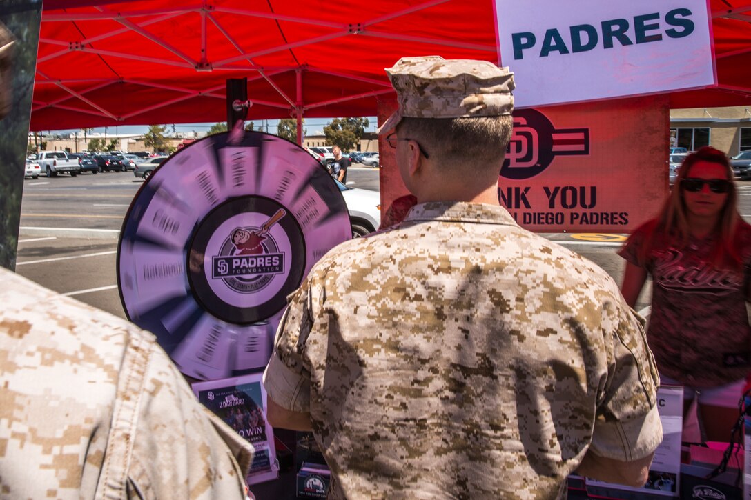 MARINE CORPS AIR STATION MIRAMAR, Calif. – Sgt. Dustin Brown, an instructor with the Center for Naval Aviation Technical Training Unit, spins a prize wheel at the San Diego Padres vendor stand during the Marine Corps Air Station Miramar Information Tickets and Tours Expo 2014, Marine Corps Air Station Miramar, Calif., June 12. Prize wheels such as this were some of the free events and offers provided for service members, department of defense employees and their families at the ITT Expo. This is the first expo the air station has hosted in five years. 