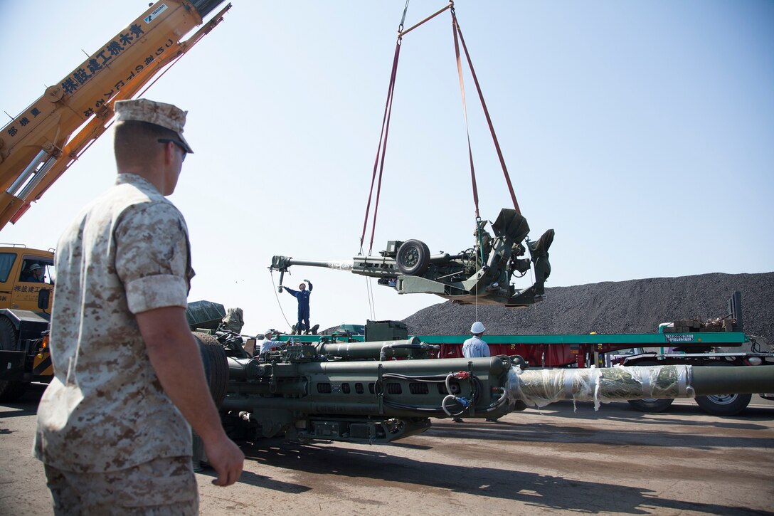 Cpl. Thomas J. Beach, a London, Ohio native, supervises the loading of a M777A2 lightweight 155mm howitzer onto a contractor’s tractor trailer June 2, 2014 at the Port of Sendai, Sendai, Japan. Six howitzers and 27 tactical vehicles moved from the port to the Ojojihara Maneuver Area, Japan, prior to Artillery Relocation Training Program 14-1. During this training Marines with Battery C, 1st Battalion, 10th Marine Regiment, currently assigned to 12th Marines, 3rd Marine Division, III Marine Expeditionary Force, under the unite deployment program, will train in relocating artillery positions, artillery live-fire, small-arms weapons tactics and other various sustainment events. Beach is a field artillery cannoneer with the battery.