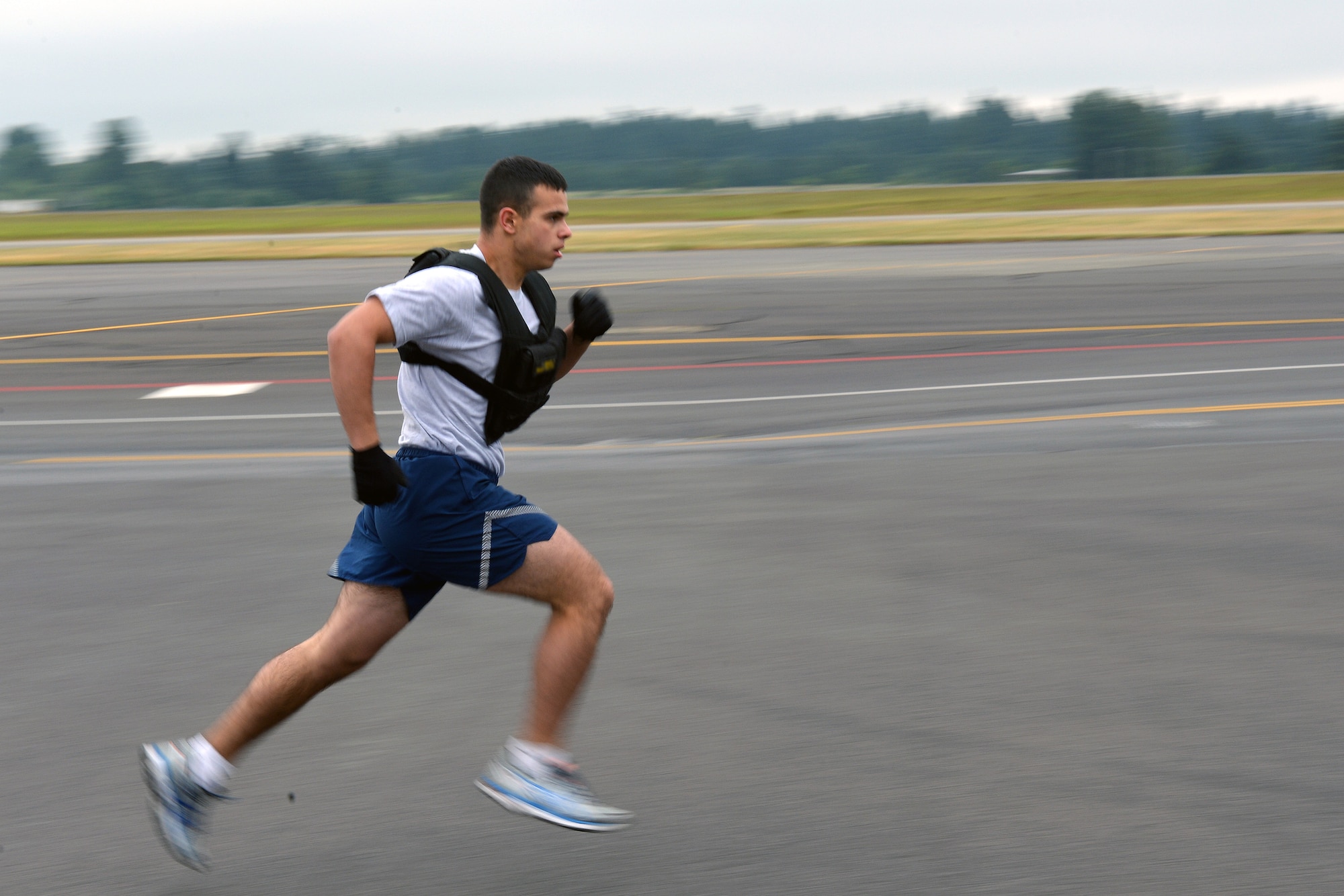 Airmen 1st Class Patrick Wright, Civil Engineer Squadron electrical systems apprentice, sprints to the finish, completing the final part of the CE fitness challenge at the fire station June 11, 2014, at Joint Base Lewis-McChord, Wash. The last part of the challenge was a sprint with a 50 pound vest, after their partner completed a stair climb with a 50 pound vest as well. (U.S. Air Force photo/Senior Airmen Brenden Marlin)