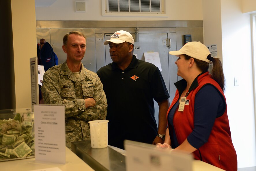 Brig. Gen. Warren Berry, Headquarters Air Mobility Command director of logistics, talks with Lynn Burnet (center) and Jo Burnet, USO volunteers at McChord Field’s Shali Center June 12, 2014, at Joint Base Lewis-McChord, Wash. Berry received a first-hand look from USO volunteers on services provided to service members who visit the center. (U.S. Air Force photo/Airman 1st Class Jacob Jimenez)        