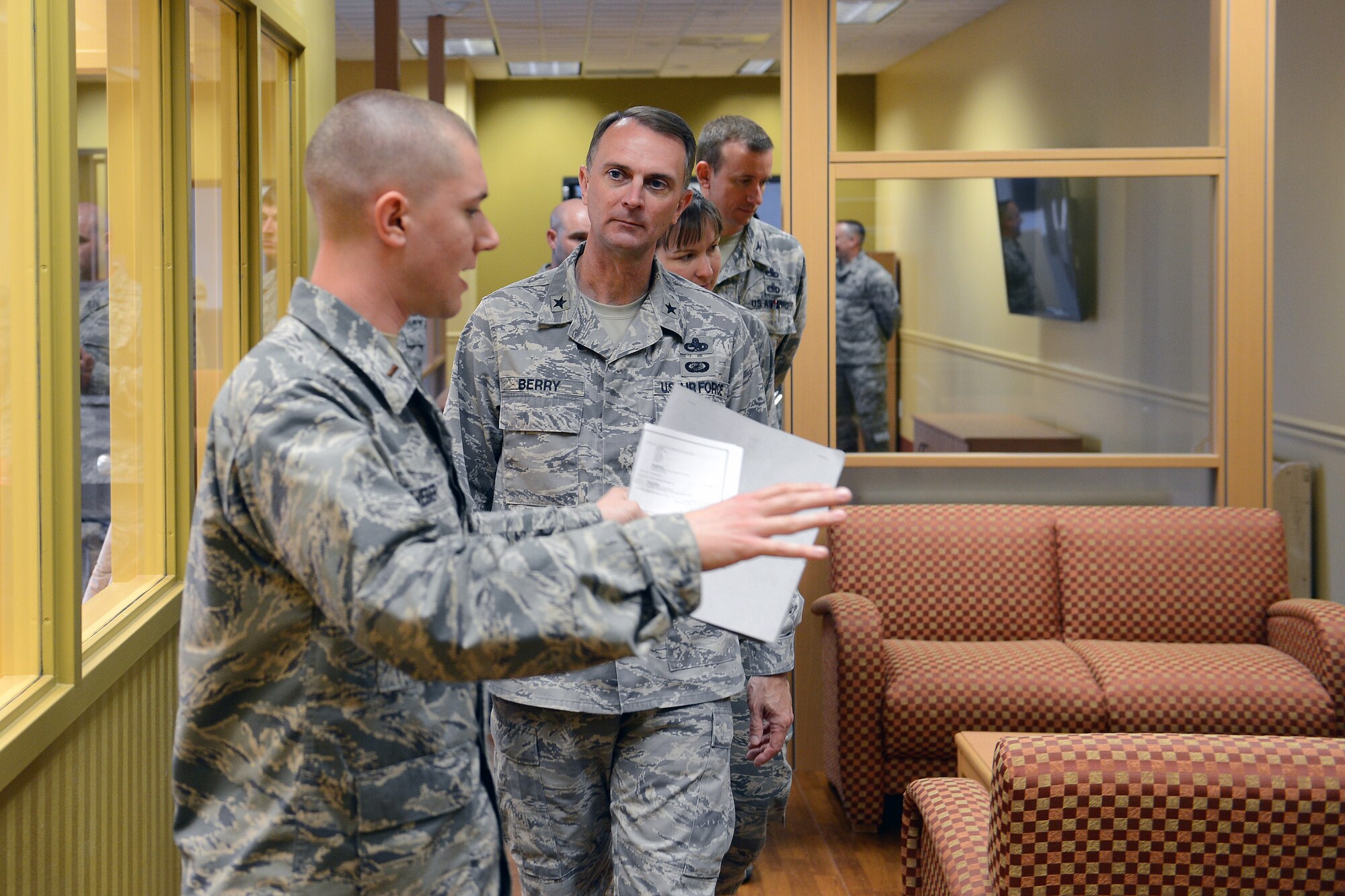 2nd Lt. Michael Weber (left), 62nd Aerial Port Squadron passenger terminal flight commander, shows Brig. Gen. Warren Berry, Headquarters Air Mobility Command director of logistics, the passenger terminal’s new family lounge during a base tour June 12, 2014, at Joint Base Lewis-McChord, Wash. During his visit, Berry was briefed on Team McChord’s prime nuclear airlift mission, joint base operations and Operation Deep Freeze. (U.S. Air Force photo/Airman 1st Class Jacob Jimenez)