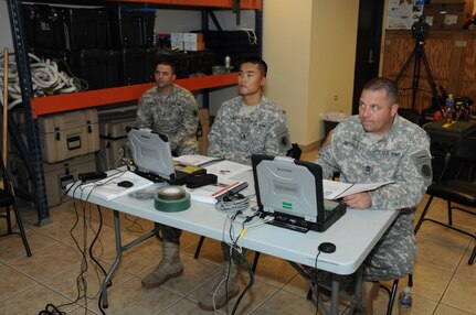 U. S. Army 1st Lt. William Jung (left) and Master Sgt. Luke Pritchard, Joint Task Force-Bravo SSAT members, listen intently as the Automated Route Reconnaissance Kit (ARRK) instructor teaches them the basics of how to use the system.  The Joint Task Force-Bravo U. S. Southern Command Situational Assessment Team (SSAT) received training and performed practical exercises with the ARRK in preparation for future Central American disaster relief missions.  It employs a ruggedized laptop computer to automatically and continuously collect road information and condition to provide situational awareness and facilitate the decision making process.  (Photo by U. S. Air National Guard Capt. Steven Stubbs)