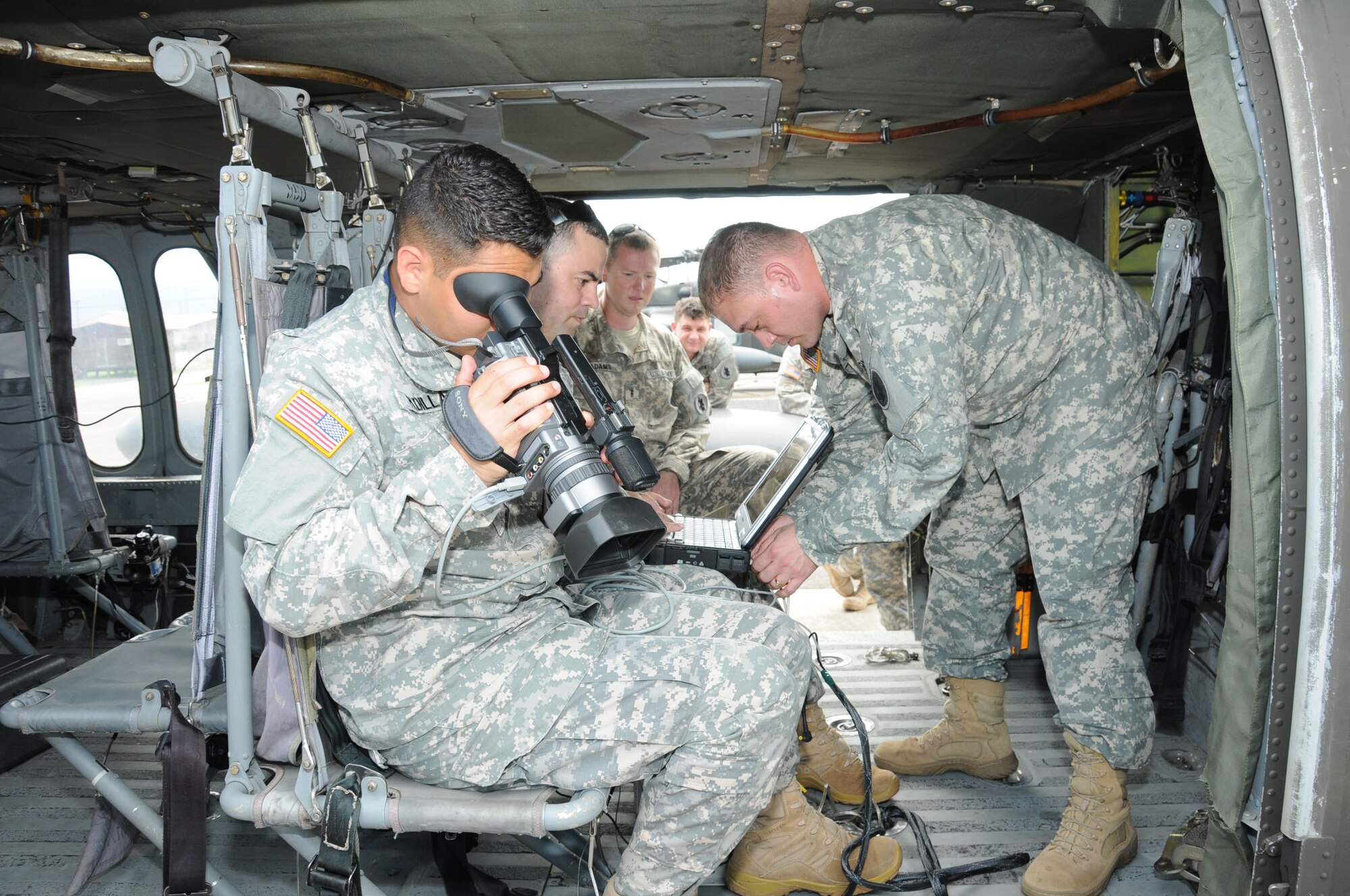 U. S. Army Sgt. Louis Padilla (left), Sgt. Francisco Padilla and Staff Sgt. Patrick Trevillion, instructors from the Army South Geospatial Planning Cell, prepare the Automated Route Reconnaissance Kit (ARRK) for an aerial route recon mission.  The Joint Task Force-Bravo U. S. Southern Command Situational Assessment Team (SSAT) received training and performed practical exercises with the ARRK in preparation for future Central American disaster relief missions.  It employs a ruggedized laptop computer to automatically and continuously collect road information and condition to provide situational awareness and facilitate the decision making process.   (Photo by U. S. Air National Guard Capt. Steven Stubbs)