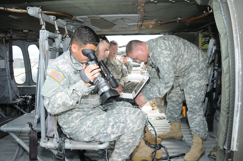 U. S. Army Sgt. Louis Padilla (left), Sgt. Francisco Padilla and Staff Sgt. Patrick Trevillion, instructors from the Army South Geospatial Planning Cell, prepare the Automated Route Reconnaissance Kit (ARRK) for an aerial route recon mission.  The Joint Task Force-Bravo U. S. Southern Command Situational Assessment Team (SSAT) received training and performed practical exercises with the ARRK in preparation for future Central American disaster relief missions.  It employs a ruggedized laptop computer to automatically and continuously collect road information and condition to provide situational awareness and facilitate the decision making process.   (Photo by U. S. Air National Guard Capt. Steven Stubbs)
