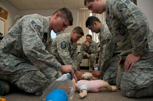 Firefighters with the 940th Civil Engineer Flight perform infant resuscitation during a Basic Life Support course at Beale Air Force Base, Calif., June 8, 2014.  Emergency responders are required to complete the training every two years. (U.S. Air Force photo by Staff Sgt. Brenda Davis/Released)