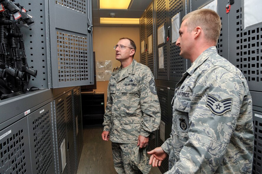 Chief Master Sgt. Marty Anderson, Eighth Air Force command chief, receives a briefing from Staff Sgt. Nicholas Niles, 2nd Security Forces Squadron Armory, on Barksdale Air Force Base, La., June 12, 2014. Anderson visited the armory as part of an immersion tour that allowed him to meet and answer questions from 2nd Bomb Wing Airmen. (U.S. Air Force photo/Airman 1st Class Benjamin Raughton)