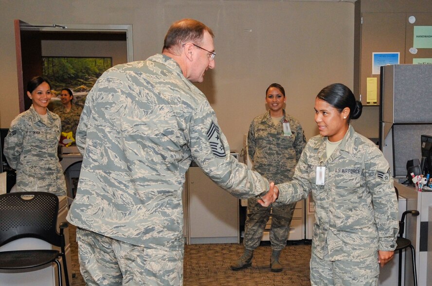 Chief Master Sgt. Marty Anderson, Eighth Air Force command chief, shakes hands with Senior Airman Laura Jimenez, 2nd Aerospace Medical Squadron public health technician, during his visit to the 2nd Medical Group on Barksdale Air Force Base, La., June 11, 2014. Jimenez briefed Anderson on the mission of the public health clinic. (U.S. Air Force photo/Airman 1st Class Benjamin Raughton)