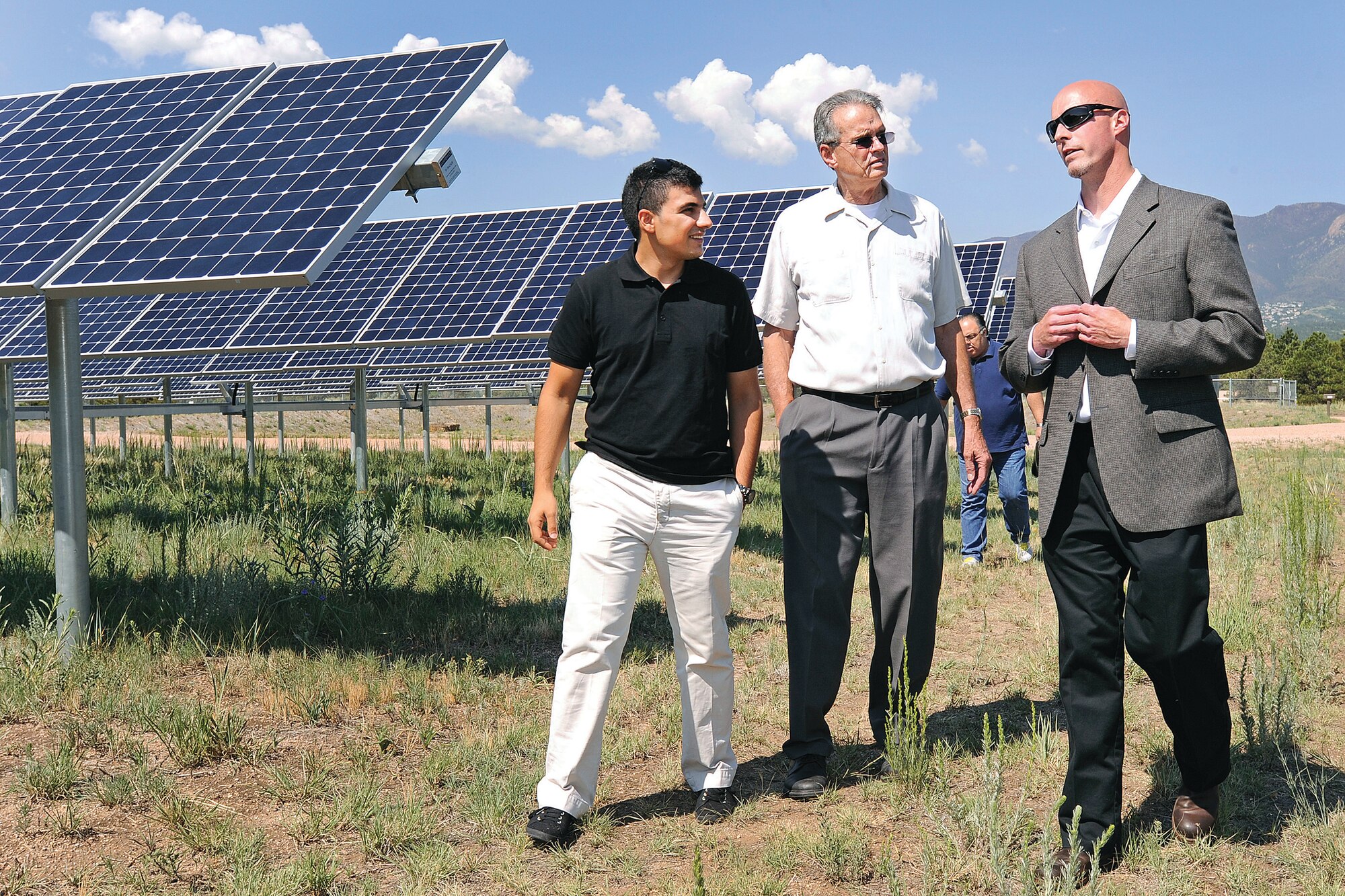 Russell Hume (right), a 10th Civil Engineer Squadron engineer, chats with Tom Hykes (middle), a 10th CES resource energy manager, and a journalist from the Republic of Cyprus (left) in July 2013 while walking through the Academy’s solar array near the south gate. (Sarah Chambers/U.S. Air Force photo)