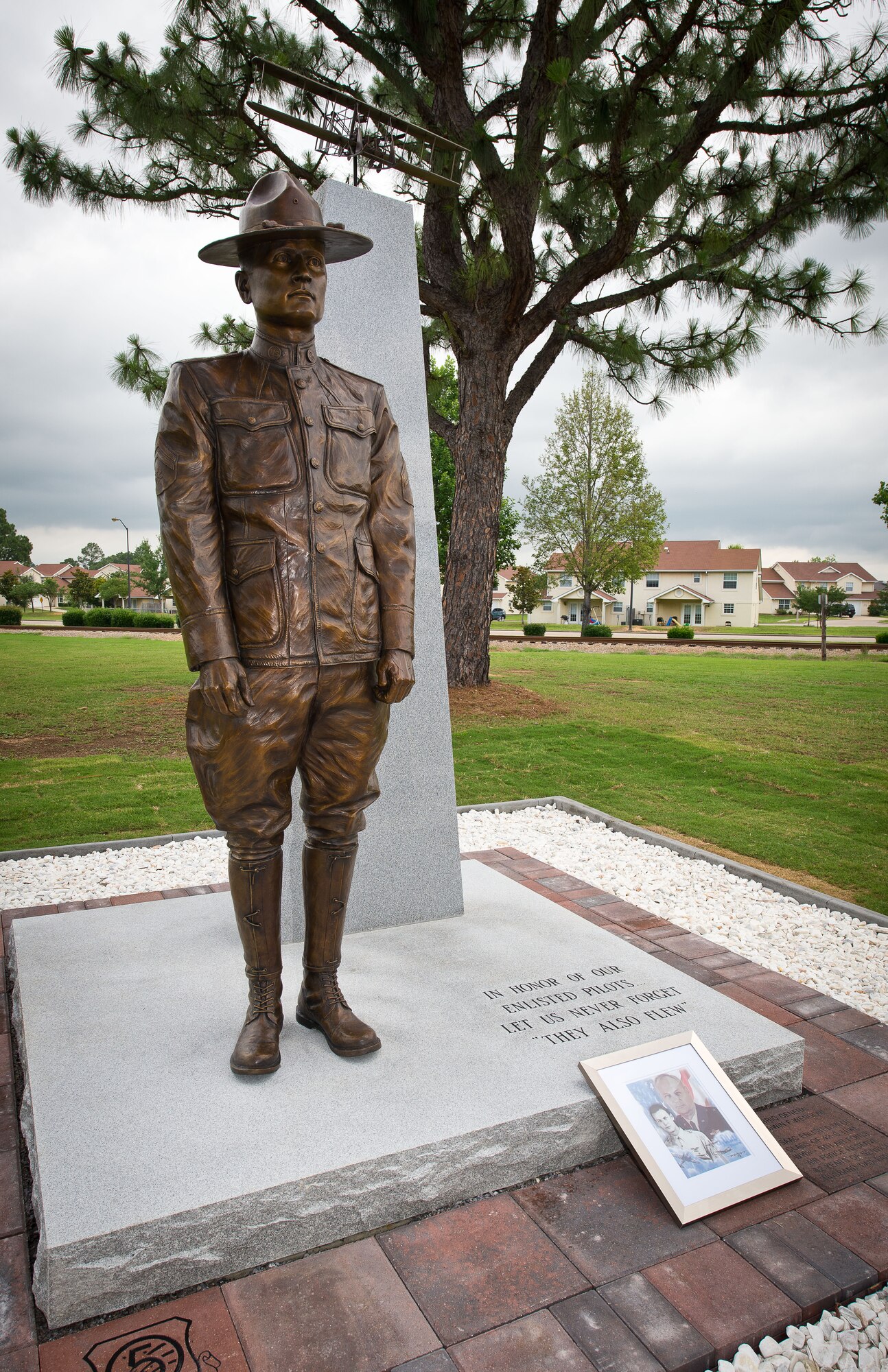 A new monument honoring the nearly 3,000 enlisted sergeant pilots who served from 1912-1957 was unveiled during a ceromony June 9, 2014, at the Enlisted Heritage Hall at Maxwell-Gunter Air Force Base. The monument depicts Cpl. Vernon L. Burge, the first enlisted pilot in military aviation, and recognizes the acomplishments of the enlisted fliers who came after him. (U.S. Air Force photo by Donna Burnett)