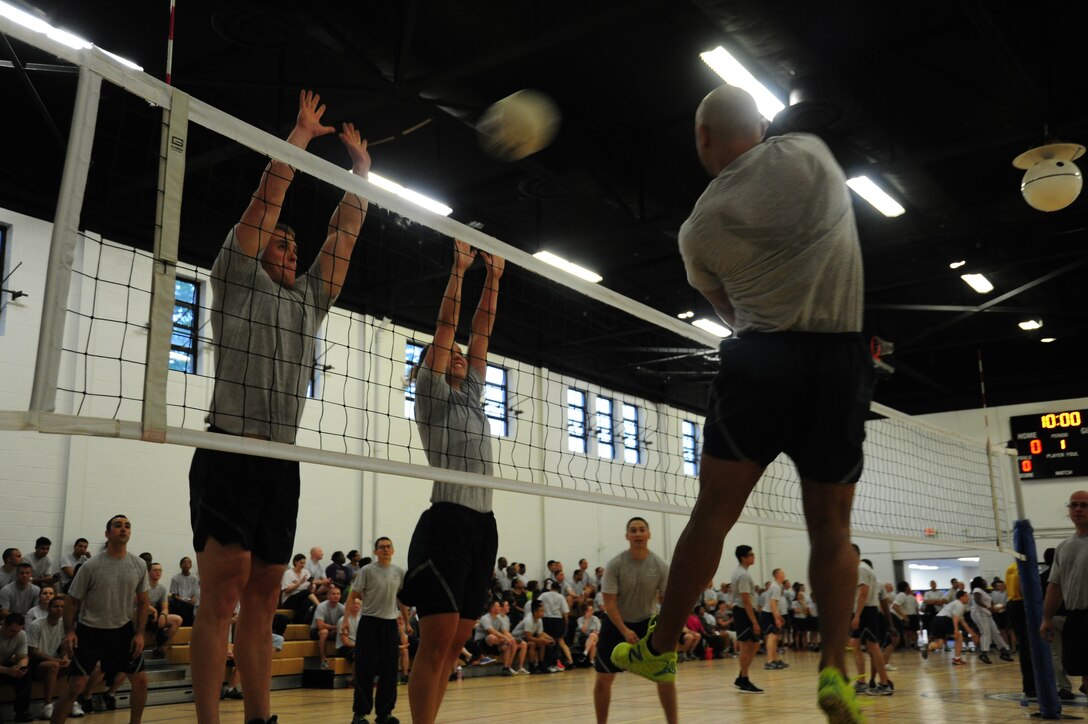 Airmen compete in a friendly volleyball tournament at Wingman Day on Joint Base Andrews, Md., Jun. 12, 2014. Wingman Day is designed to promote physical fitness, the wingman concept and core values. (U. S. Air Force photo/Airman 1st Class Joshua R. M. Dewberry)