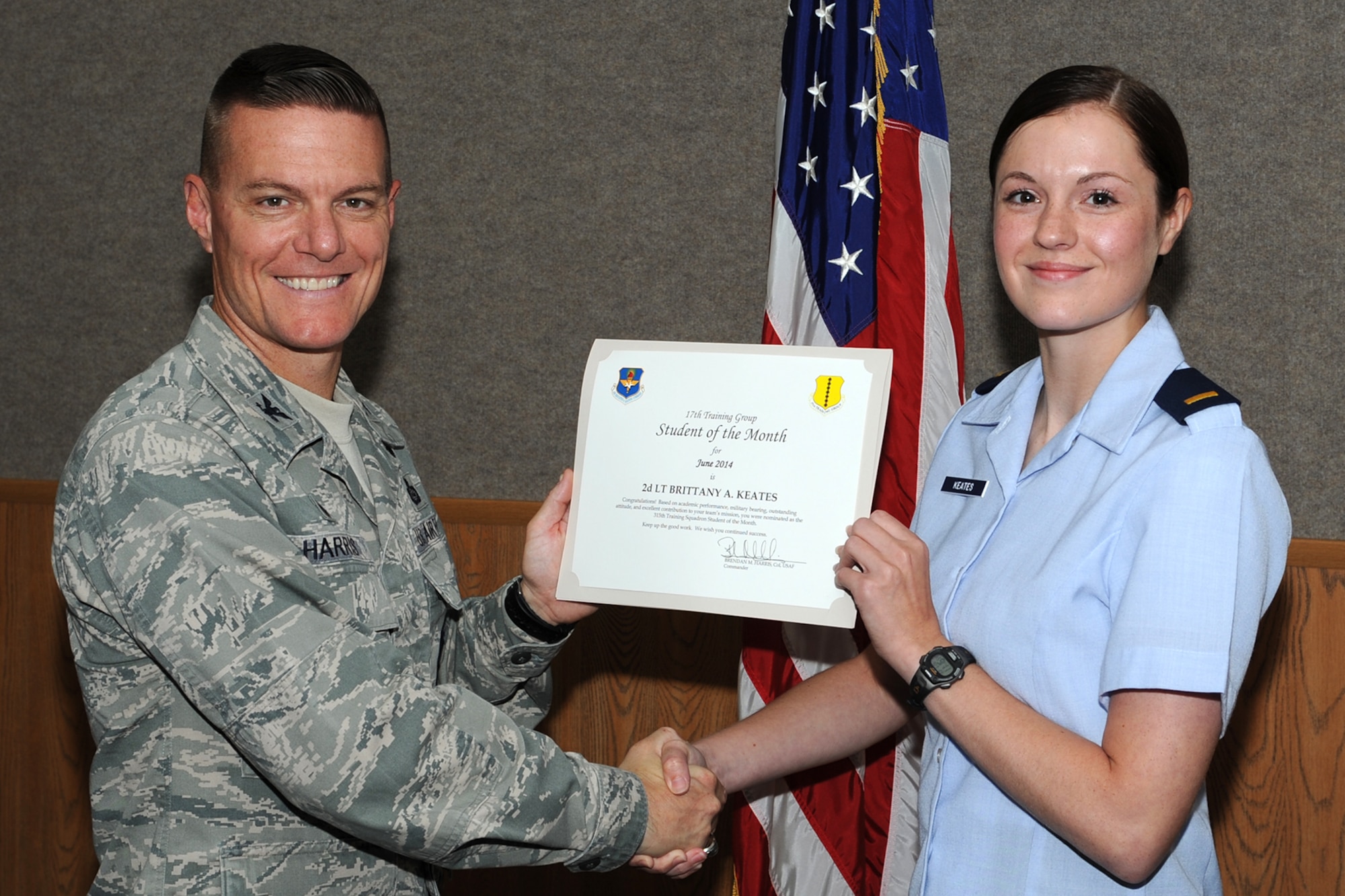 GOODFELLOW AIR FORCE BASE, Texas -- Col. Brendan M. Harris, 17th Training Group Commander, presents the 315th Training Squadron Officer Student of the Month award for April 2014 to 2nd Lt. Brittany A. Keates June 6. (U.S. Air Force photo/ Senior Airman Michael Smith)