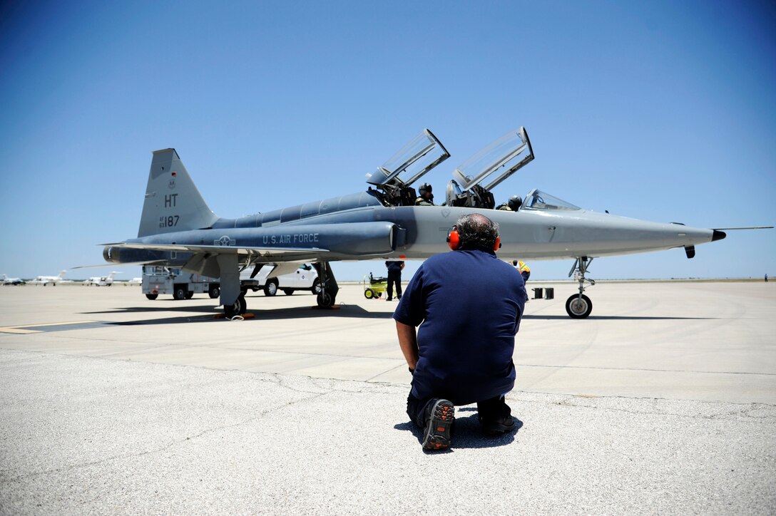 Robert Marques, 47th Maintenance Directorate aircraft servicer, observes an AT-38B Talon during start-up at the flight line on Laughlin Air Force Base, Texas, June 10, 2014. The 47th Flying Training Wing Maintenance Directorate, also known as Laughlin Consolidated Services Aircraft Maintenance, is responsible for furnishing quality aircraft, support, and services to its customers. (U.S. Air Force photo by Staff Sgt. Steven R. Doty, 47th Flying Training Wing.)(Released)