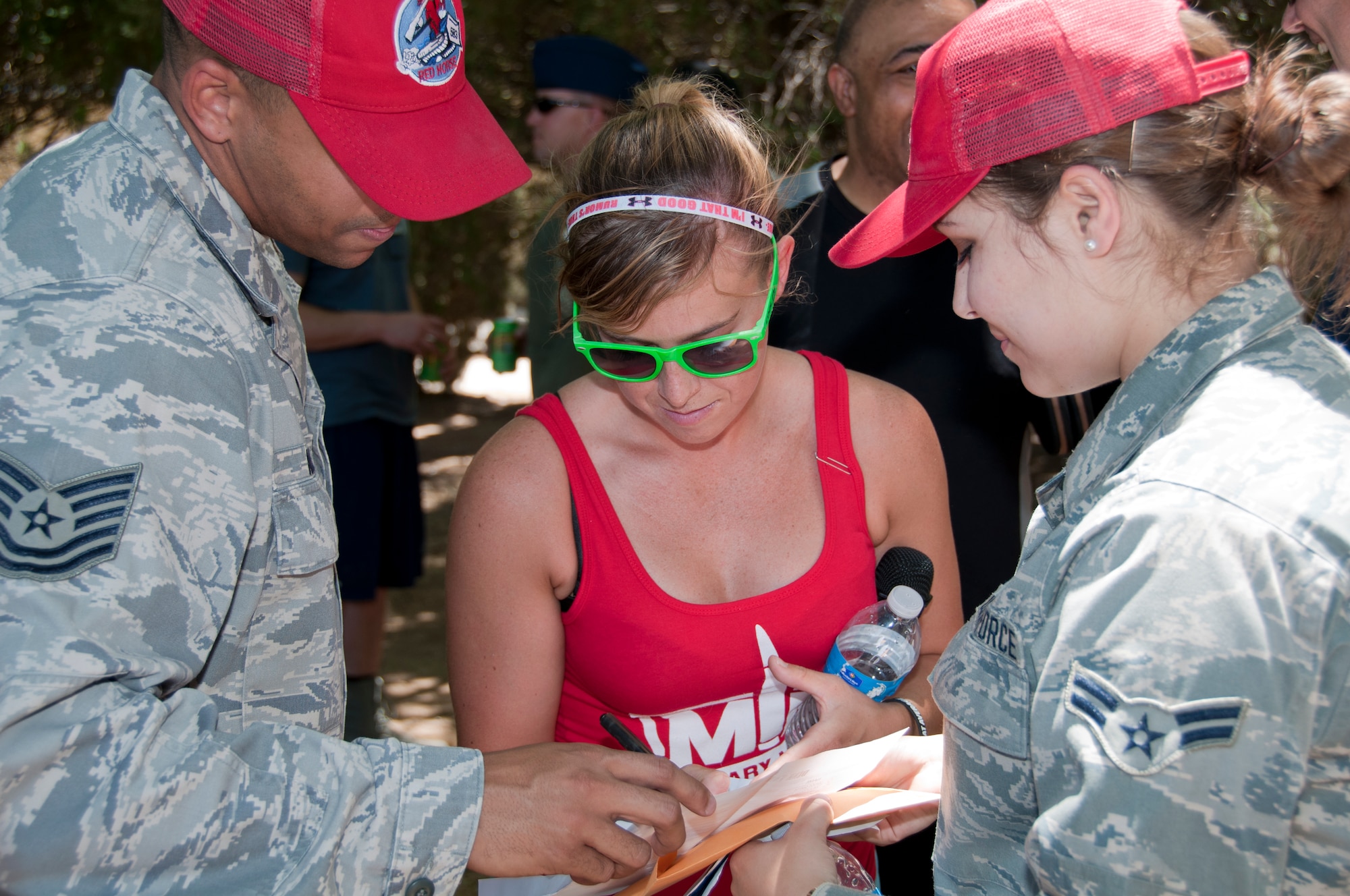 Senior Airman Krystal Eddis, Rising 6 Council president, and two 583rd Red Horse Squadron members coordinate details for the dunk tank during the 940th Wing's annual Family Day picnic at Beale Air Force Base, Calif., June 8, 2014. The Rising 6 Council unites junior enlisted members in professional development and volunteer activities.  (U.S. Air Force photo by Staff Sgt. Brenda Davis/Released)