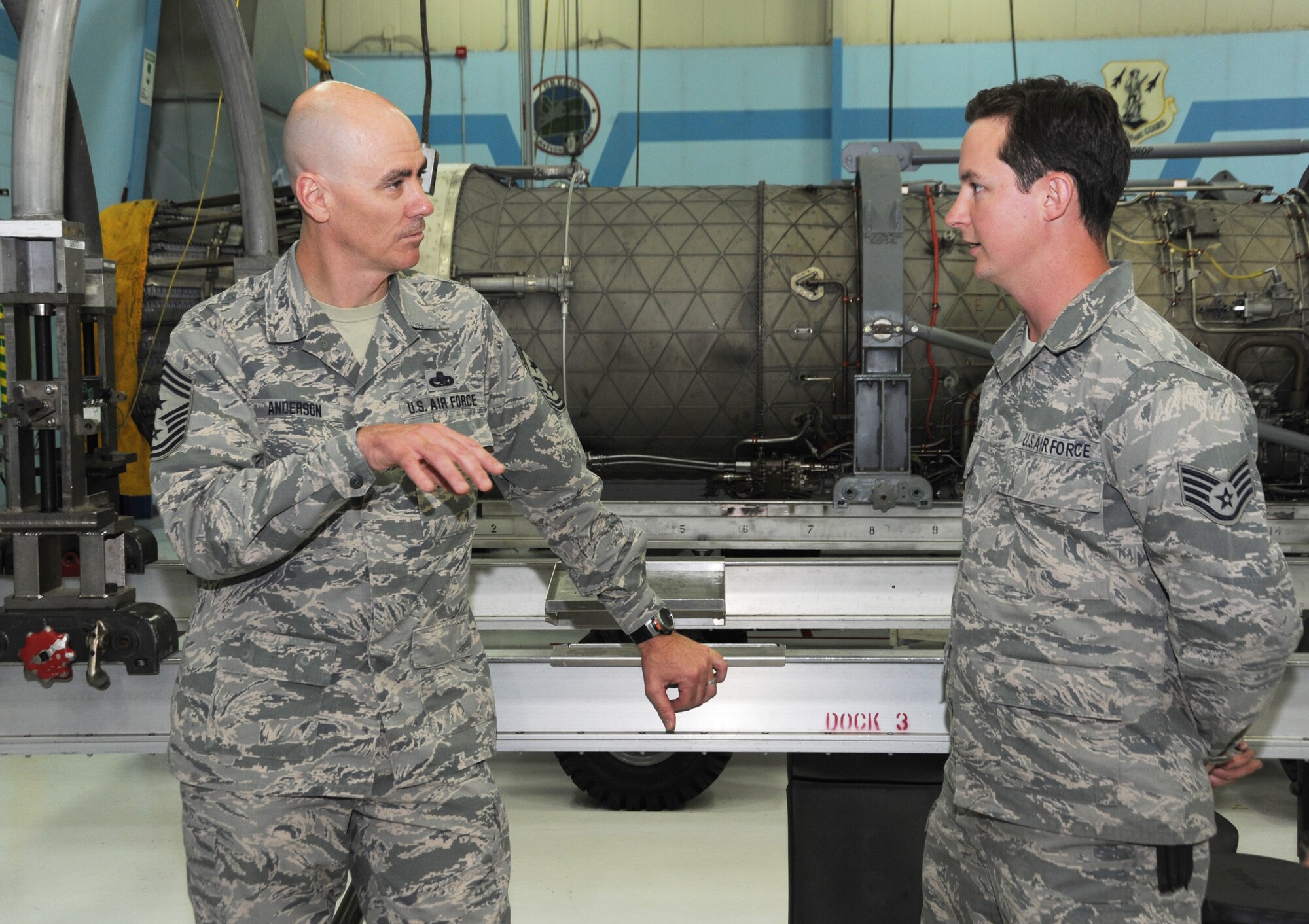 Ronald C. Anderson Jr., Command Chief Master Sgt., 1st Air Force, left, talks with Staff Sgt. Allen, 142nd Fighter Wing Maintenance Group, right, during his tour of the Portland Air National Guard Base, Ore., June 10, 2014. (Air National Guard photo by Tech. Sgt. John Hughel, 142nd Fighter Wing Public Affairs/Released)
