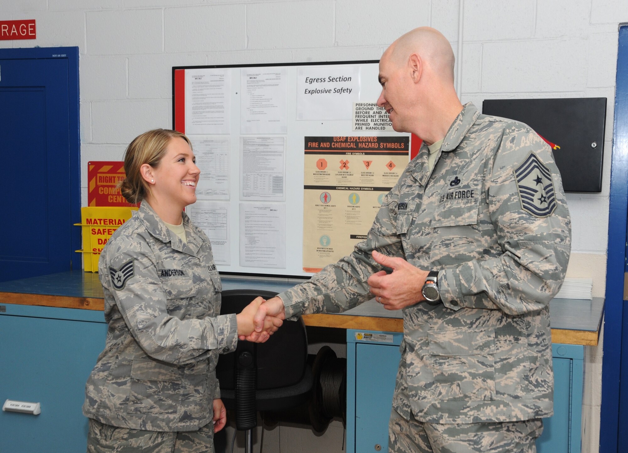 Ronald C. Anderson Jr., Command Chief Master Sgt., 1st Air Force, right, gives his Chief Coin to Staff Sgt. Jennifer Anderson, left, of the 142nd Fighter Wing Maintenance Group, during his tour of the Portland Air National Guard Base, Ore., June 10, 2014. (Air National Guard photo by Tech. Sgt. John Hughel, 142nd Fighter Wing Public Affairs/Released)