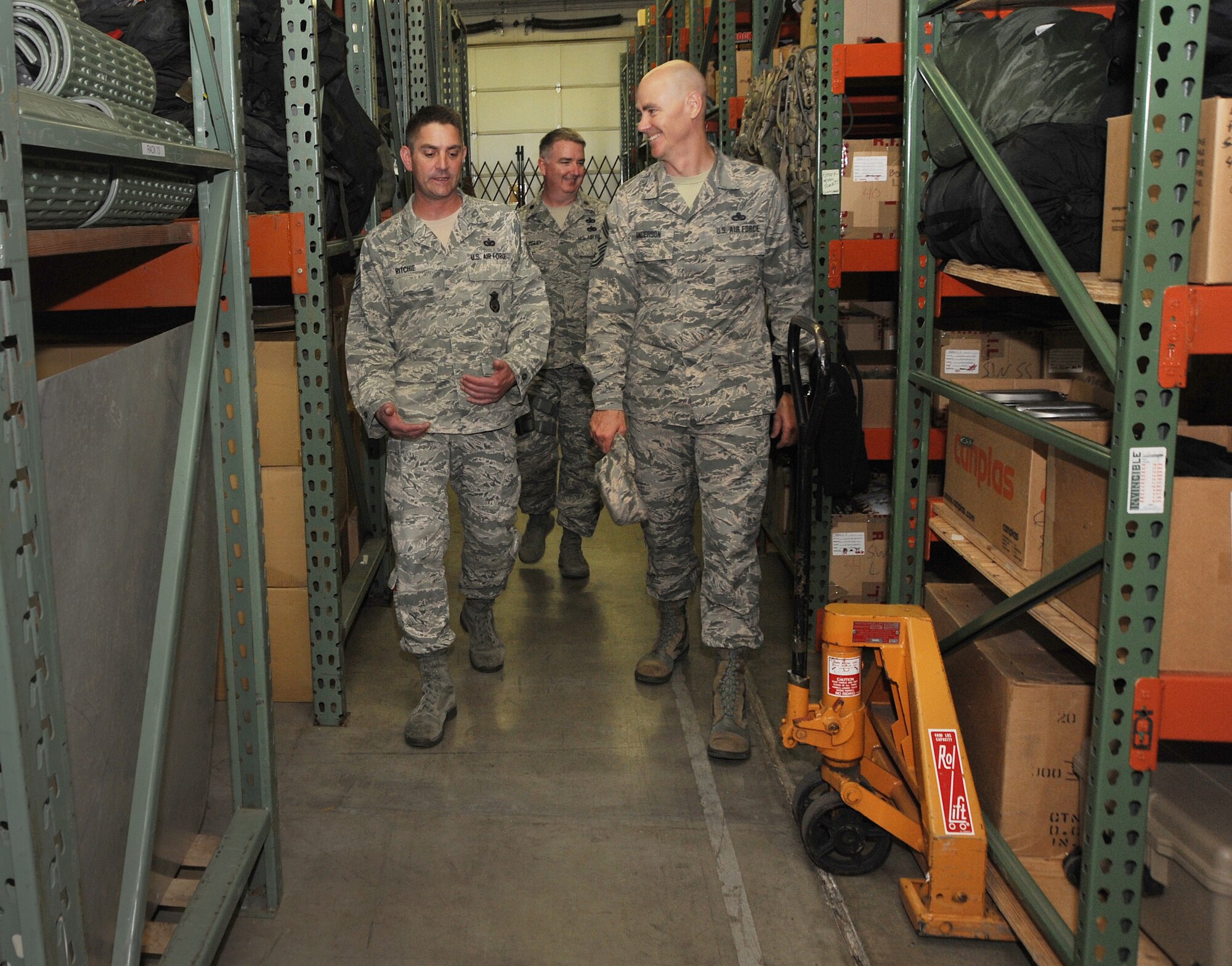 Staff Sgt. Matthew Ritchie, left, assigned to the 142nd Security Forces Squadron, walks Ronald C. Anderson Jr., Command Chief Master Sgt., 1st Air Force, right, thought the supply area used by the Security Forces Airmen during his visit to the Portland Air National Guard Base, Ore., June 10, 2014. (Air National Guard photo by Tech. Sgt. John Hughel, 142nd Fighter Wing Public Affairs/Released)