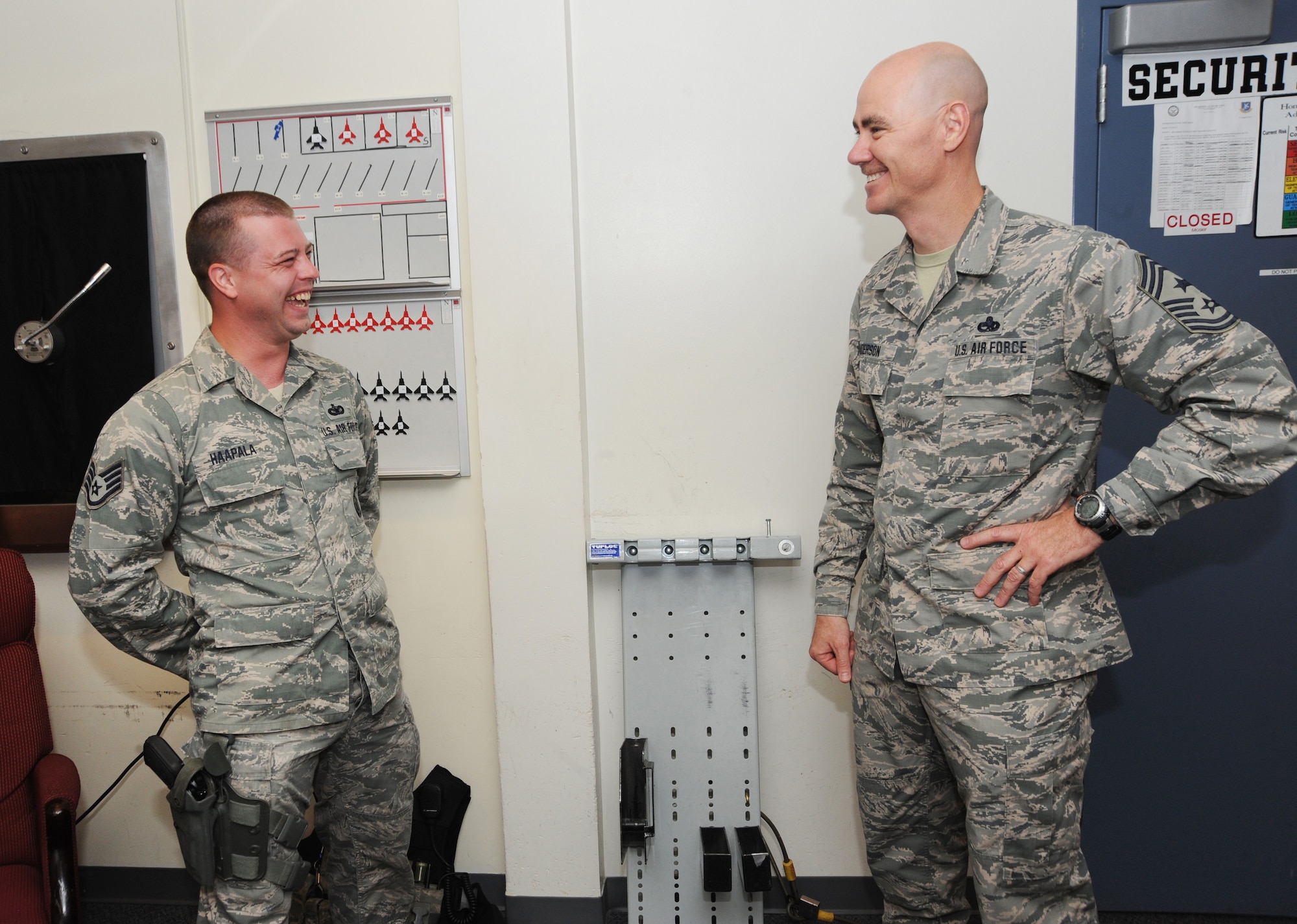 Staff Sgt. Jonathan Haapala, left, assigned to the 142nd Security Forces Squadron, shares a lighter moment with Ronald C. Anderson Jr., Command Chief Master Sgt., 1st Air Force, right, during his visit to the Portland Air National Guard Base, Ore., June 10, 2014. (Air National Guard photo by Tech. Sgt. John Hughel, 142nd Fighter Wing Public Affairs/Released)
