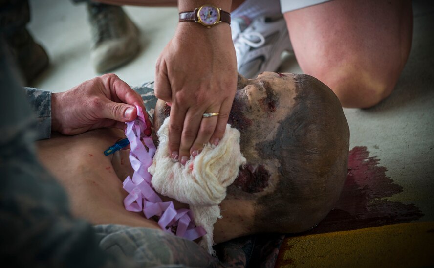U.S. Air Force Capt. Wesley Arnold, 823d Base Defense Squadron medical cell officer in charge, performs tactical combat casualty care with media personnel during the “Inside Combat Rescue: The Last Stand” media day at Moody Air Force Base, Ga., June 11, 2014. Throughout the day, media members participated in multiple demonstrations to get a closer look at Moody’s 820th Base Defense Group and their capabilities. (U.S. Air Force photo by Senior Airman Douglas Ellis/Released)
