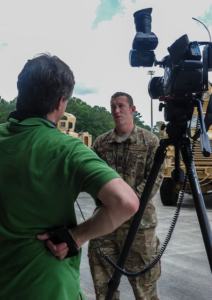 U.S. Air Force Capt. Joshua Loomis, 755th Expeditionary Security Forces Squadron chief of intelligence, speaks about his experience filming National Geographic Channel’s “Inside Combat Rescue: The Last Stand” with Lars Schwetje, Gannett Military Times multimedia journalist, at Moody Air Force Base, Ga., June 11, 2014. This is the second iteration of “Inside Combat Rescue” which will air starting June 15, 2014. (U.S. Air Force photo by Airman 1st Class Alexis Millican/Released)