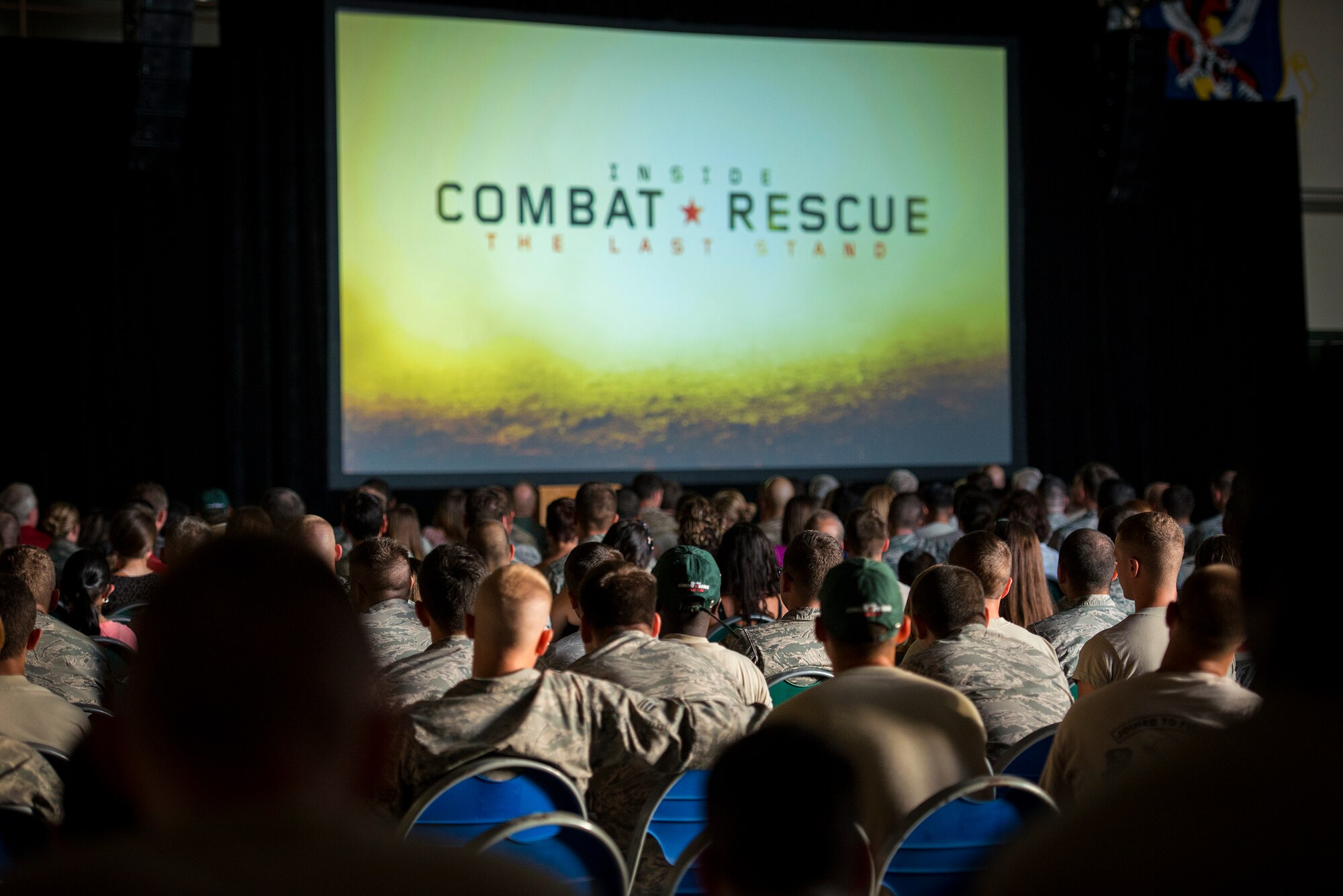 Airmen and their families watch the world premiere of National Geographic Channel’s “Inside Combat Rescue: The Last Stand” at Moody Air Force Base, Ga., June 11, 2014. The special featured Moody Airmen from the 822d Base Defense Squadron during their latest deployment where they were assigned to Reaper teams of the 755th Expeditionary Security Forces Squadron.  (U.S. Air Force photo by Airman 1st Class Ryan Callaghan/Released)