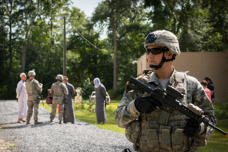U.S. Air Force Staff Sgt. Eddie Morgan II, 822nd Base Defense Squadron fire team leader, holds security as part of a key leader engagement exercise during the “Inside Combat Rescue: The Last Stand” media day at Moody Air Force Base, Ga., June 11, 2014. Fire teams commonly reach out to Maliks, Afghan village leaders, to strengthen and maintain positive relationships. (U.S. Air Force photo by Airman 1st Class Ryan Callaghan/Released)