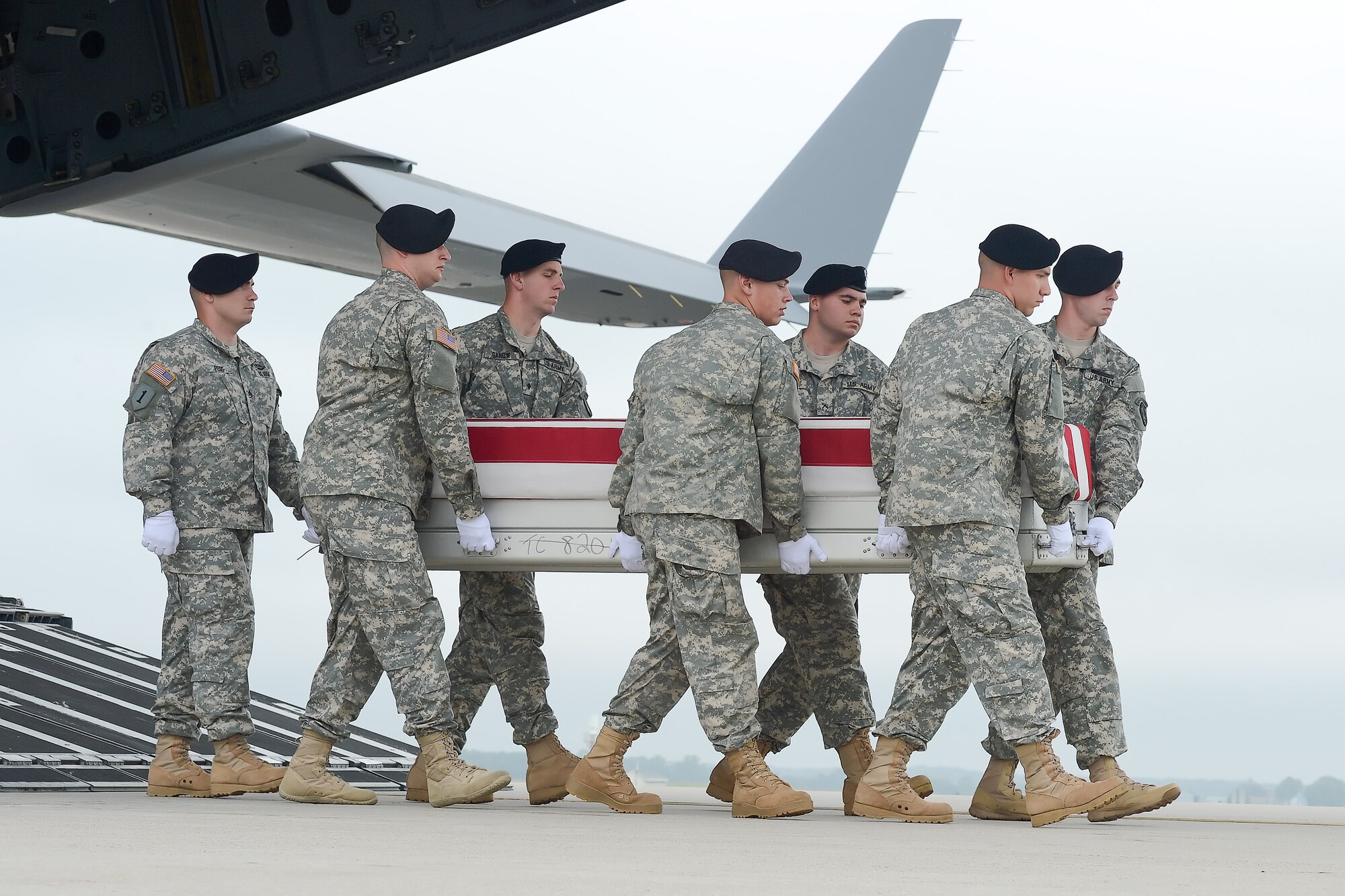 A U.S. Army carry team transfers the remains of Cpl. Justin R. Clouse of Sprague, Wash., during a dignified transfer June 12, 2014, at Dover Air Force Base, Del. Clouse was assigned to the 2nd Battalion, 12th Infantry Regiment, 4th Infantry Brigade Combat Team, 4th Infantry Division, Fort Carson, Colo. (U.S. Air Force photo/Greg L. Davis)