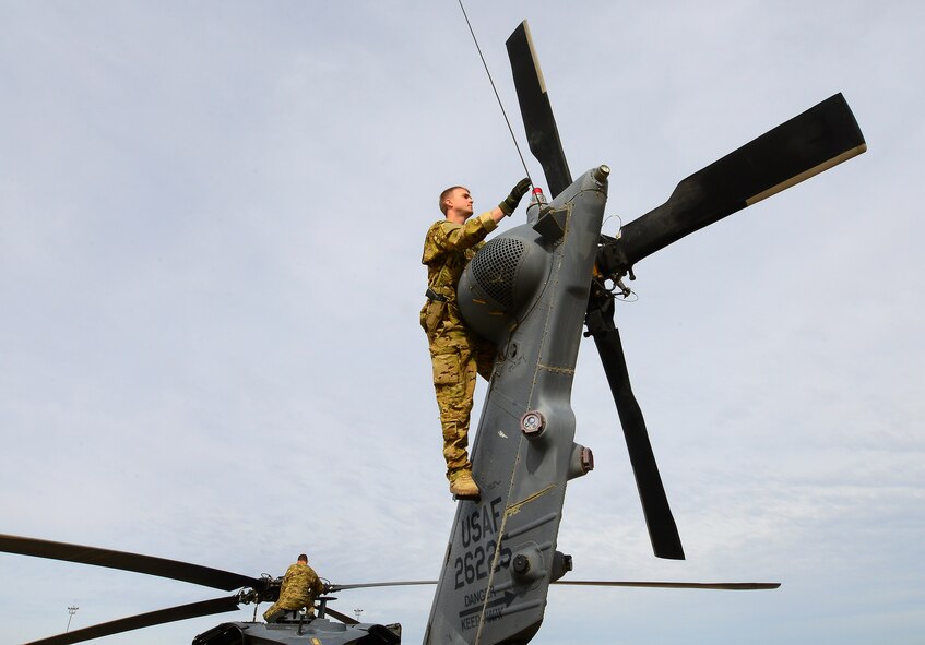 DAVIS-MONTHAN AIR FORCE BASE, Ariz. – A special mission aviation Airmen assigned to the 305th Rescue Squadron, check the rotor blades of their unit’s HH-60G Pave Hawk helicopter during a pre-flight inspection March 4 looking for any deficiencies.  The 305th RQS is assigned to the 943rd Rescue Group, which is assigned to the 920th Rescue Wing, Patrick AFB, Fla. The 943rd RQG trains and equips Citizen Airmen to perform personnel recovery operations worldwide. (U.S. Air Force photo/Tech. Sgt. Frank Oliver)