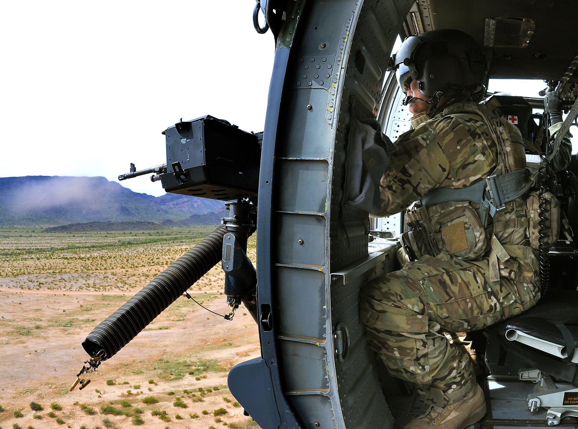 DAVIS-MONTHAN AIR FORCE BASE, Ariz. –Air Force special mission aviation Airman assigned to the Air 305th Rescue Squadron, shoots the .50-caliber machine gun onboard a HH-60G Pave Hawk helicopter during a training mission March 4. The 305th RQS is assigned to the 943rd Rescue Group, which is assigned to the 920th Rescue Wing, Patrick AFB, Fla. The 943rd RQG trains and equips Citizen Airmen to perform personnel recovery operations worldwide. (U.S. Air Force photo/Tech. Sgt. Frank Oliver) 