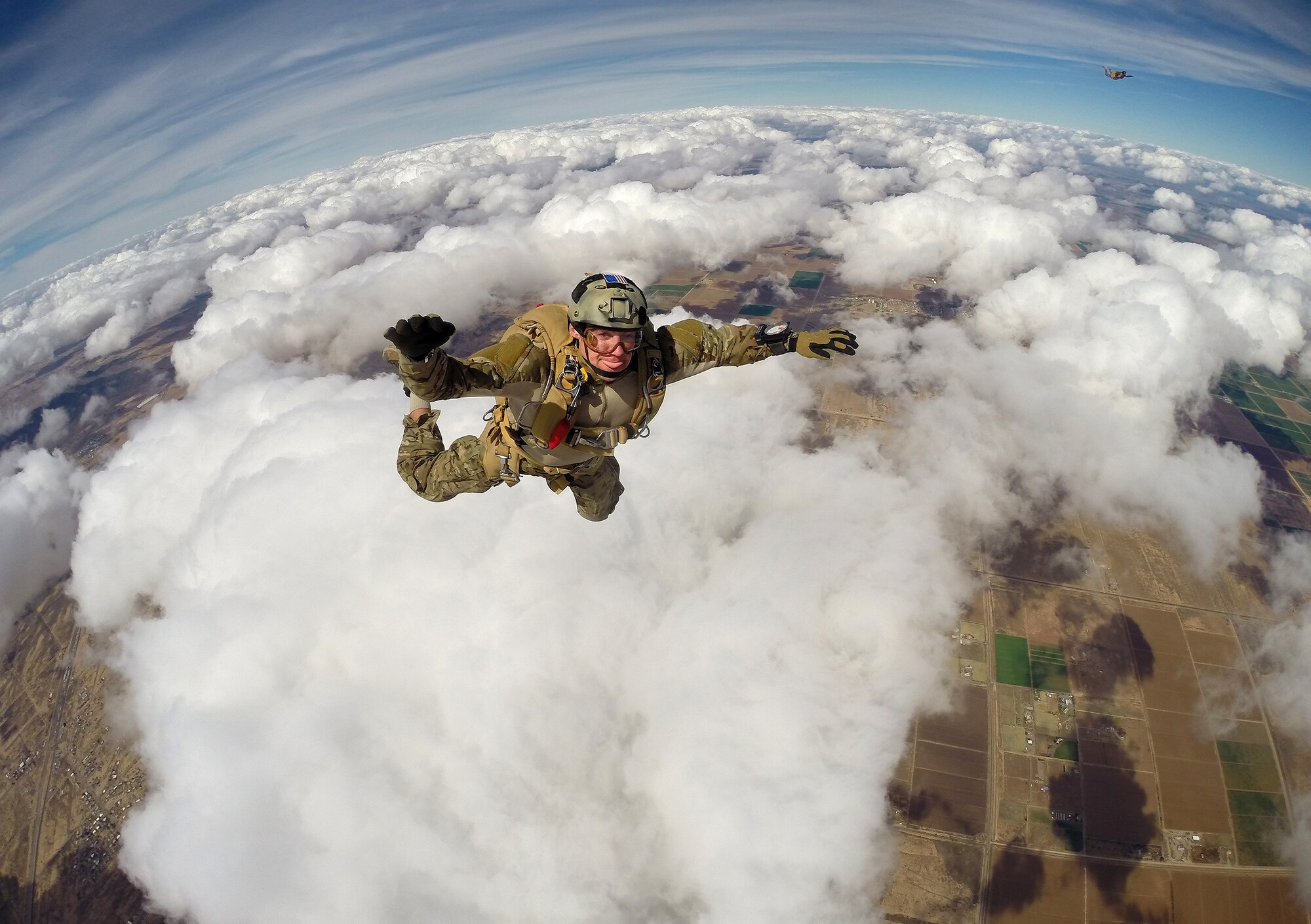 DAVIS-MONTHAN AIR FORCE BASE, Ariz. – A pararecueman (PJ) assigned to the 306th Rescue Squadron prepares to deploy his parachute over the Eloy, Arizona skies during a training mission March 2. PJ’s are specifically organized, trained and equipped to conduct personnel recovery operations in hostile or denied areas as a primary mission. The 306th RQS is a subordinate unit of the 943rd Rescue Group, which trains and equips Citizen Airmen to perform personnel recovery operations worldwide. (U.S. Air Force photo/Tech. Sgt. Frank Oliver)
