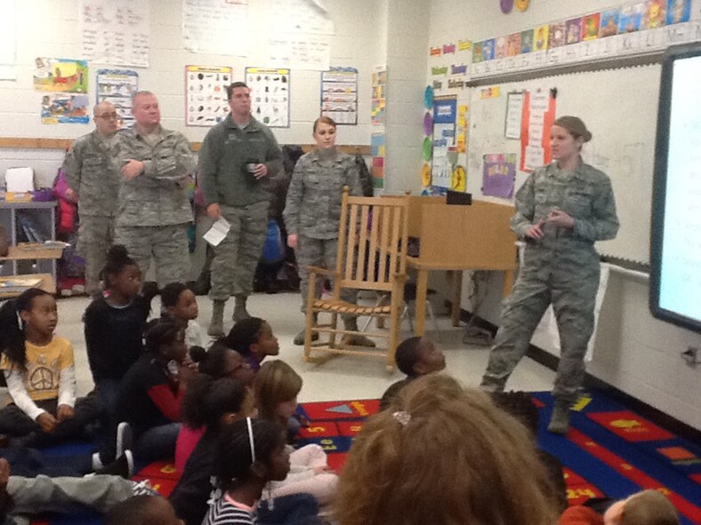 Airmen from the 28th Operational Weather Squadron, speak to a fourth-grade class at R.E. Davis Elementary School about weather, Sumter, S.C. Airmen from the 28th OWS were recorded volunteering for about 200 hours for the school year 2013-14. The Airmen mentored and tutored as well as helping the school out with many other events. (U.S. Air Force photo by Senior Airman Tabatha Zarrella/Released)
