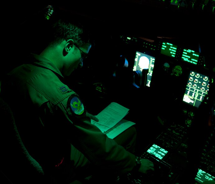U.S. Air Force Capt. Nathan King, 39th Airlift Squadron aircraft commander from Dyess Air Force Base, Texas, enters flight coordinates into a navigation system June 5, 2014, at Pope Army Airfield, Fort Bragg, N.C. Joint opportunities and exercises are becoming more common for the 317th Airlift Group as funding for training increases and future mission requirements evolve. (U.S. Air Force photo by Senior Airman Peter Thompson/Released)
