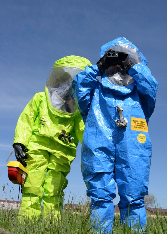 Airman 1st Class Ronald Reynolds, 28th Civil Engineer Squadron emergency management technician, and Staff Sgt. Kathleen Couillard, 28th Medical Operations Squadron bioenvironmental technician, test air quality during a simulated radiation scenario as part of an Integrated Base Emergency Response Capabilities Training at Ellsworth Air Force Base, S.D., May 22, 2014. The test determines the type of respiratory protection emergency response teams need in order to safely operate in a compromised environment. (U.S. Air Force photo by Senior Airman Anania Tekurio/Released)