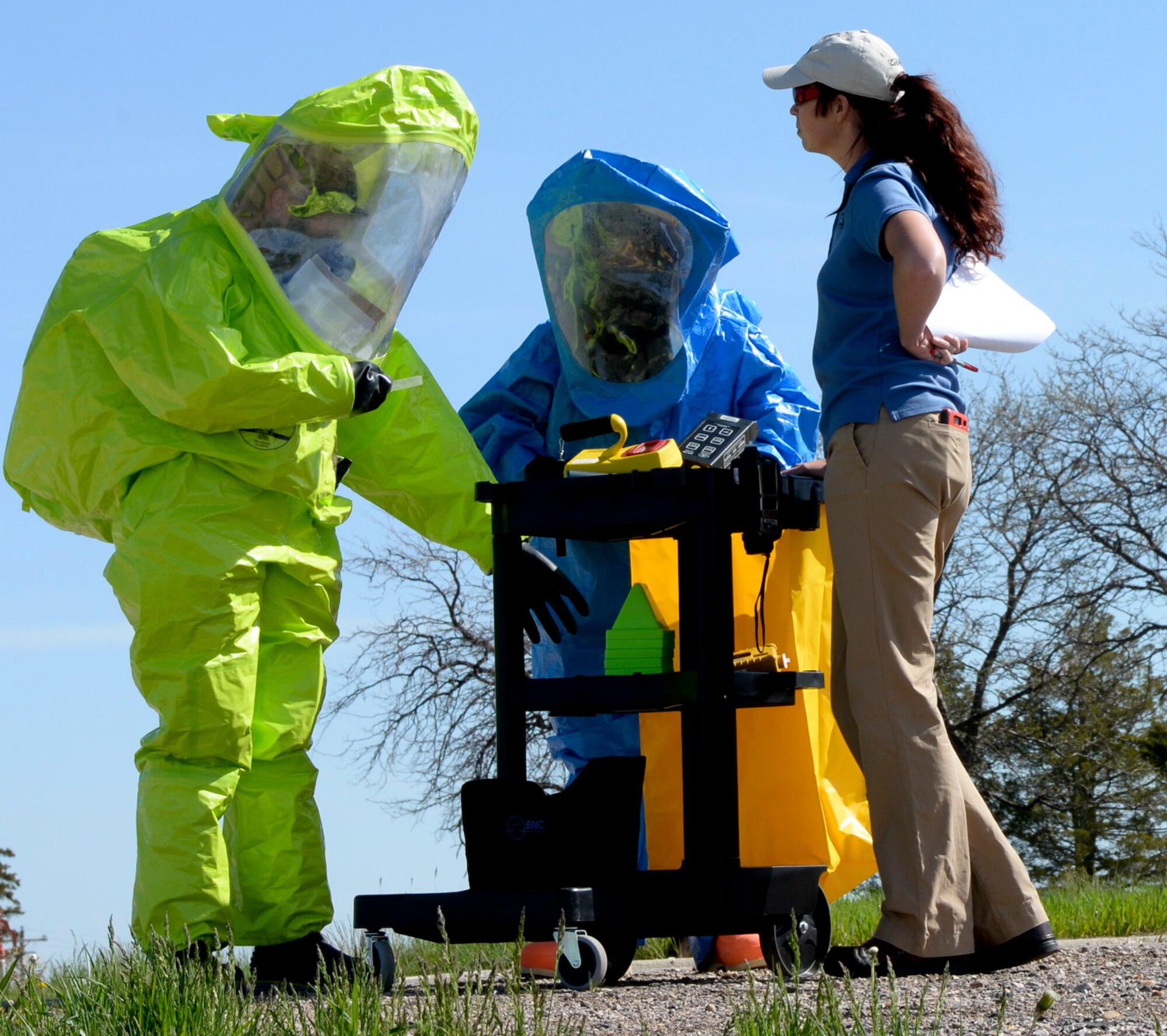 Morgan Lindsey, Alliance Solutions Group Inc. analyst, evaluates how well Staff Sgt. Kathleen Couillard, 28th Medical Operations Squadron bioenvironmental technician, and Airman 1st Class Ronald Reynolds, 28th Civil Engineer Squadron emergency management technician, perform a task during an Integrated Base Emergency Response Capabilities Training at Ellsworth Air Force Base, S.D., May 22, 2014. Couillard and Reynolds were evaluated on actions they would take in response to an unsafe environment and how to implement proper safety measures. (U.S. Air Force photo by Senior Airman Anania Tekurio/Released))  