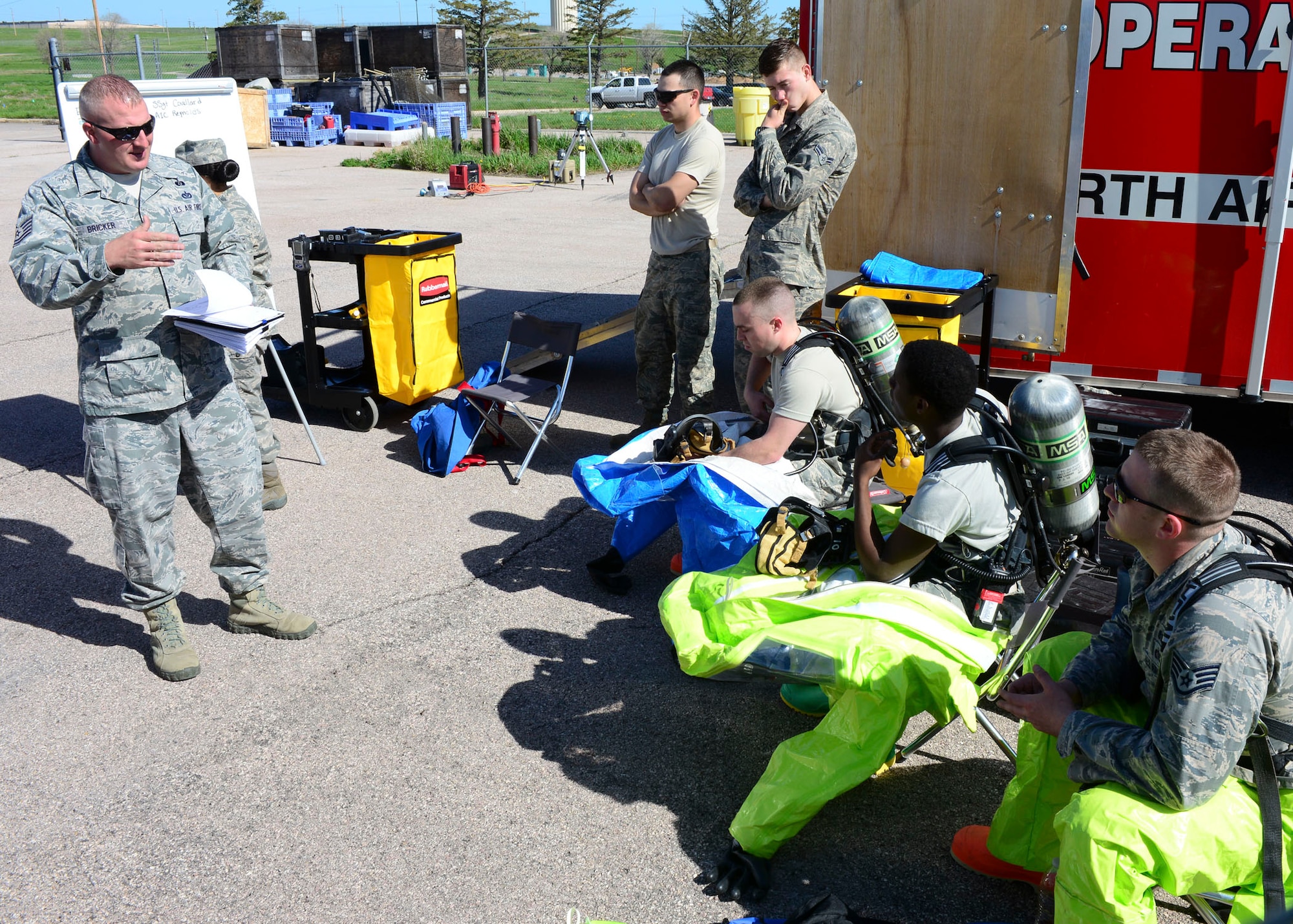 Tech. Sgt. Timothy Bricker, 28th Civil Engineer Squadron emergency management NCO in charge, briefs Airmen on the situation they are facing during an Integrated Base Emergency Response Capabilities Training at Ellsworth Air Force Base, S.D., May 22, 2014.  Two teams of Airmen participated in simulated radiation scenarios requiring them to test air levels for radiation and establish safety zones. (U.S. Air Force photo by Senior Airman Anania Tekurio/Released)  