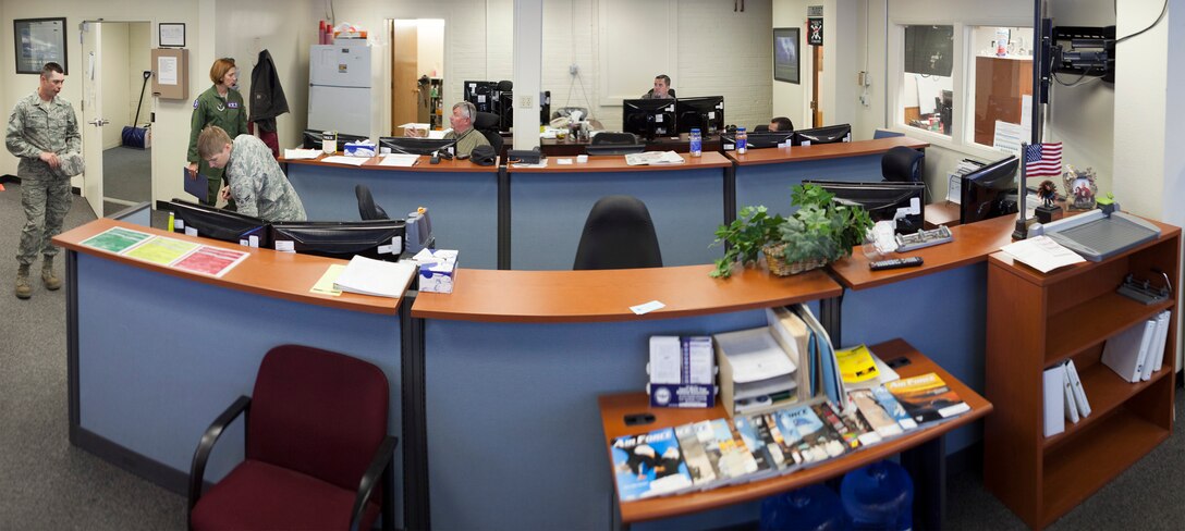 This photo mosaic, created June 11, 2014, from 10 separate images, shows the large room where the 90th Communication Squadron's Communication Focal Point assist walk-in customers man the phones and track work orders. (U.S. Air Force photo illustration by R.J. Oriez)