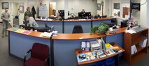 This photo mosaic, created June 11, 2014, from 10 separate images, shows the large room where the 90th Communication Squadron's Communication Focal Point assist walk-in customers man the phones and track work orders. (U.S. Air Force photo illustration by R.J. Oriez)