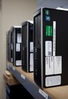 Computers line a self in the Client System Technician shop down the hall from the 90th Communication Squadron’s Communication Focal Point June 11, 2014. The computers are getting their software updated and security patches installed. (U.S. Air Force photo by R.J. Oriez)