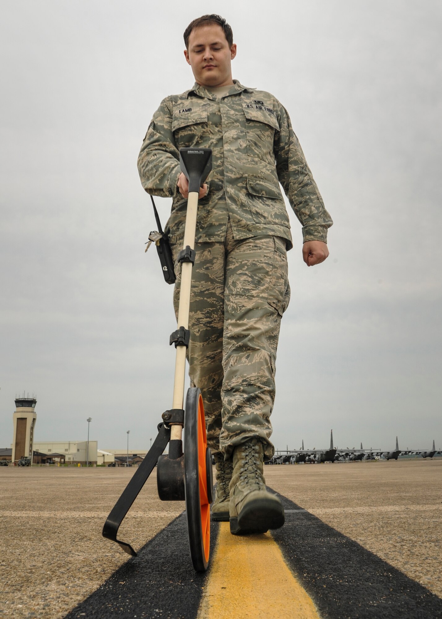 Senior Airman Jordy Lamb, a 19th Operations Support Squadron airfield management craftsman, measures a line along the flightline June 12, 2014, at Little Rock Air Force Base, Ark. Lines must be measured frequently to ensure the safe landing, taxiing and parking of aircraft. (U.S. Air Force photo by Airman 1st Class Harry Brexel)