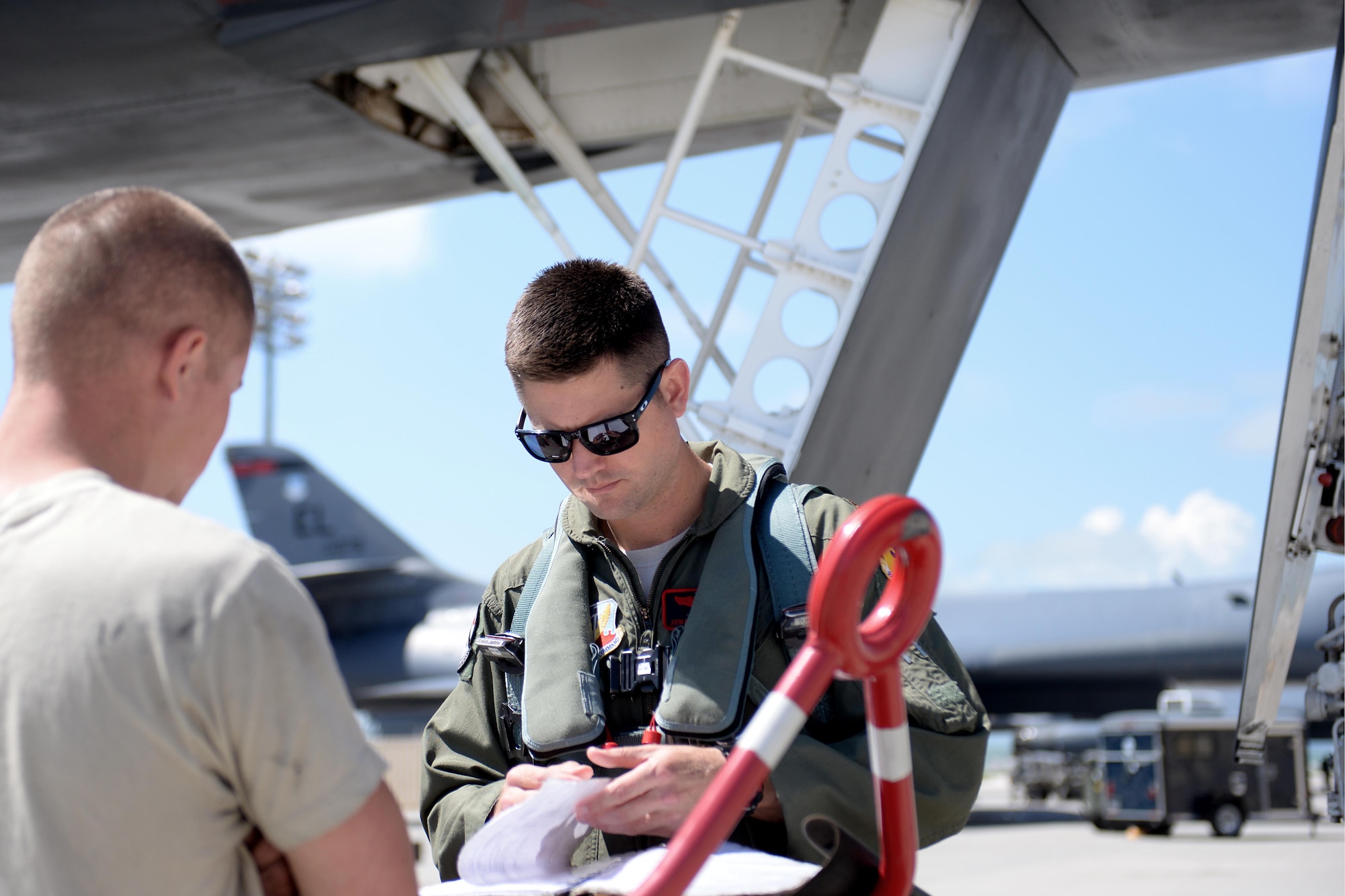 Maj. Jonathan Slinkard, 34th Bomb Squadron B-1 pilot, reviews aircraft forms prior to take off at Ellsworth Air Force Base, S.D., June 3, 2014. Base aircrews employed the munitions assembled by Airmen and Sailors as a part of a joint mission exercise. (U.S. Air Force photo by Airman 1st Class Rebecca Imwalle/Released)