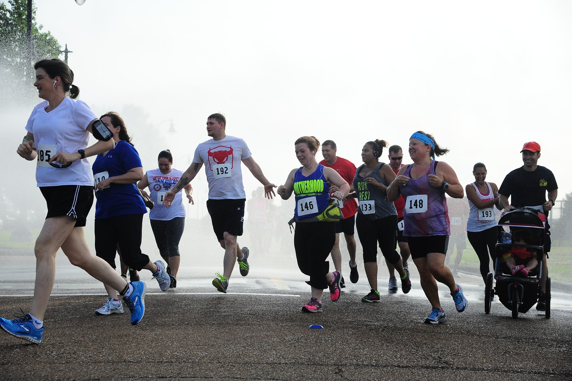 Runners sprint through a stream of water during the Water Works Run early in the morning June 7 during the 5k run. There were three races available: the 5k, 10k, and half marathon. All three races raised money for the Air Force Ball Committee. The next fundraiser for the committee is the Air Force Ball Drawdown which is scheduled to be held Aug. 8. (U.S. Air Force Photo/Senior Airman Stephanie Englar)