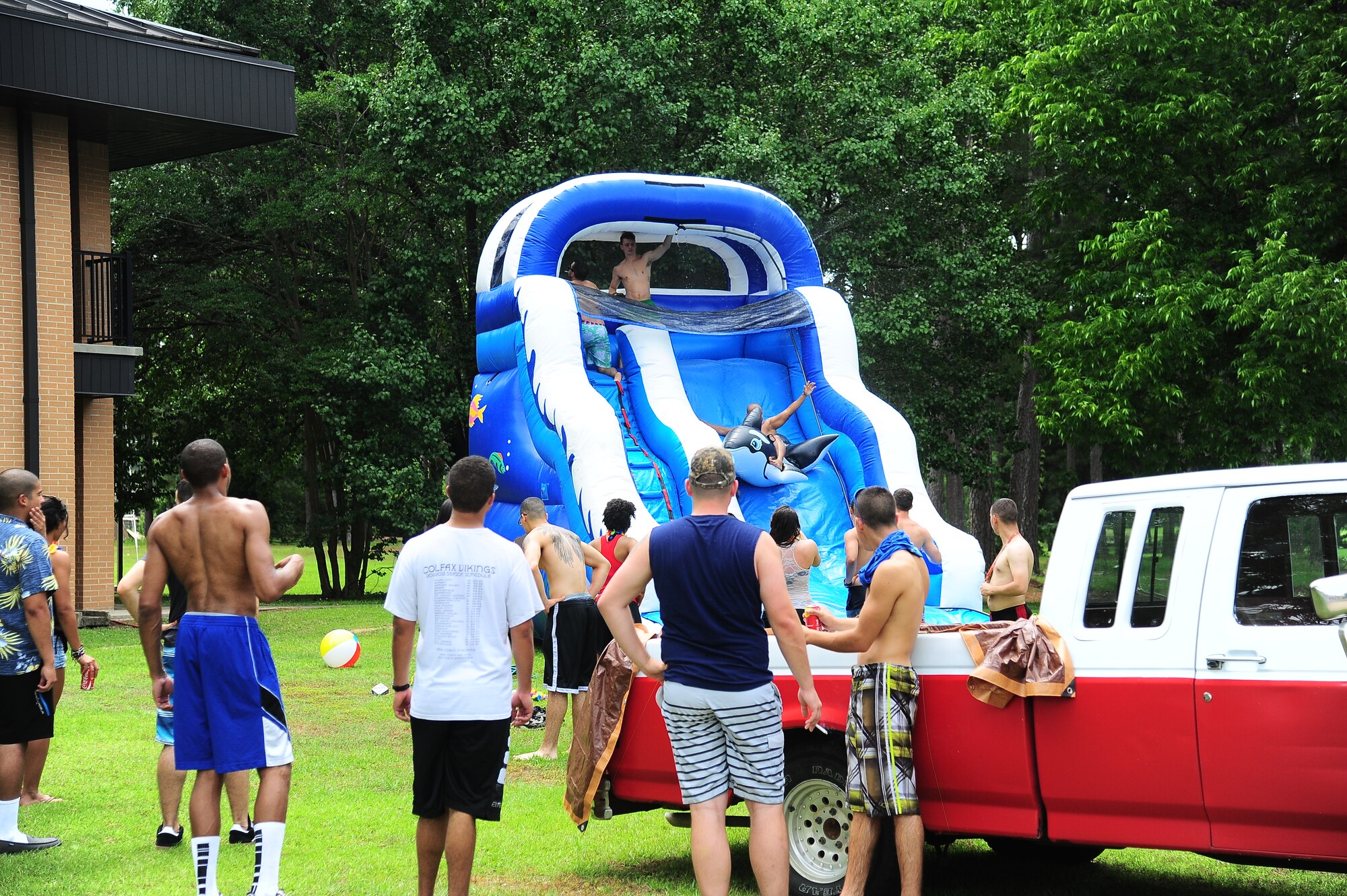 Airman 1st Class Parth Shah, 14th Medical Operations Squadron, rides “Whoopie” the inflatable whale down the water slide at the 2nd Annual Enlisted Dorm Summer Bash. Airmen enjoyed activities such as basketball, volleyball, a water slide, and a “redneck swimming pool”. The event was sponsored by the Base Chapel, the BLAZE 5/6, Top 3, First Sergeant Council, the 14th Force Support Squadron and Outdoor Recreation. (U.S. Air Force Photo/Senior Airman Stephanie Englar)