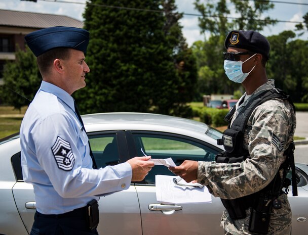 Chief Master Sergeant Mark Bronson, 628th Air Base Wing command chief, participates in the Disease Containment Exercise by checking in with a 628th Security Forces Squadron member before being medically evaluated by a member of the 628th Medical Group to determine if he had been infected June 4, 2014, at Joint Base Charleston, S.C. Personnel from the 437th Airlift Wing and the 628th Air Base Wing, along with Naval Nuclear Power Training Command  Sailors and approximately 85 volunteers participated in the exercise. (U. S. Air Force photo/ Senior Airman Dennis Sloan)
