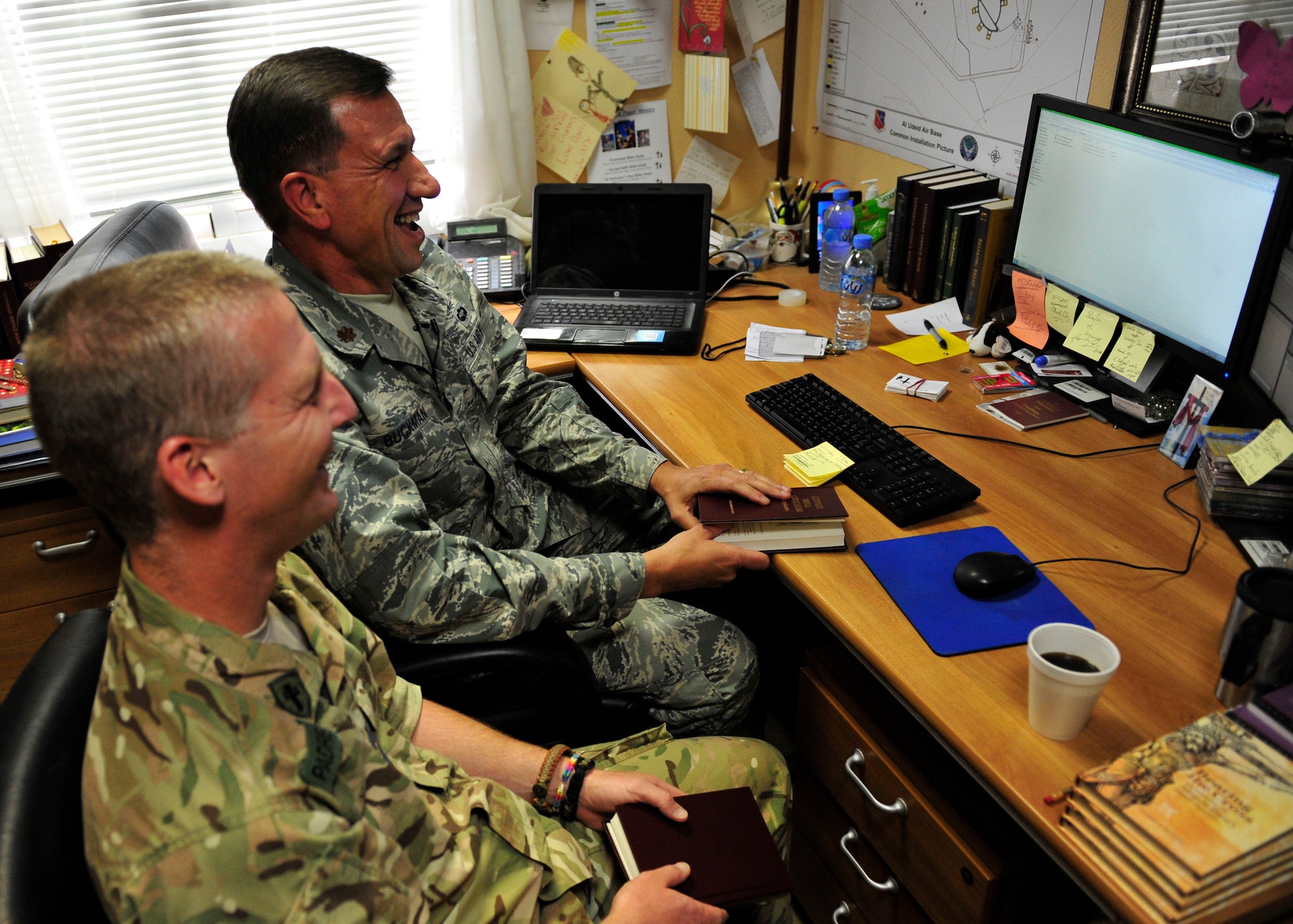 U.S Air Force Maj. James Buckman, 379th Air Expeditionary Wing deputy chaplain, and Royal Air Force Capt. Michael Chatfield, chaplain, lead the first Bible study on Defense Communications Online, a worldwide communications systems at Al Udeid Air Base, Qatar, June 5, 2014. This new system will allow Service members to watch the live broadcast or from the archive database, along with being able to ask chaplains questions over chat during the service.  Beckman’s home station is the 108th Air Refueling Wing in New Jersey and his hometown is Bridgewater, New Jersery. (U.S. Air Force photo by Senior Airman Colin Cates)